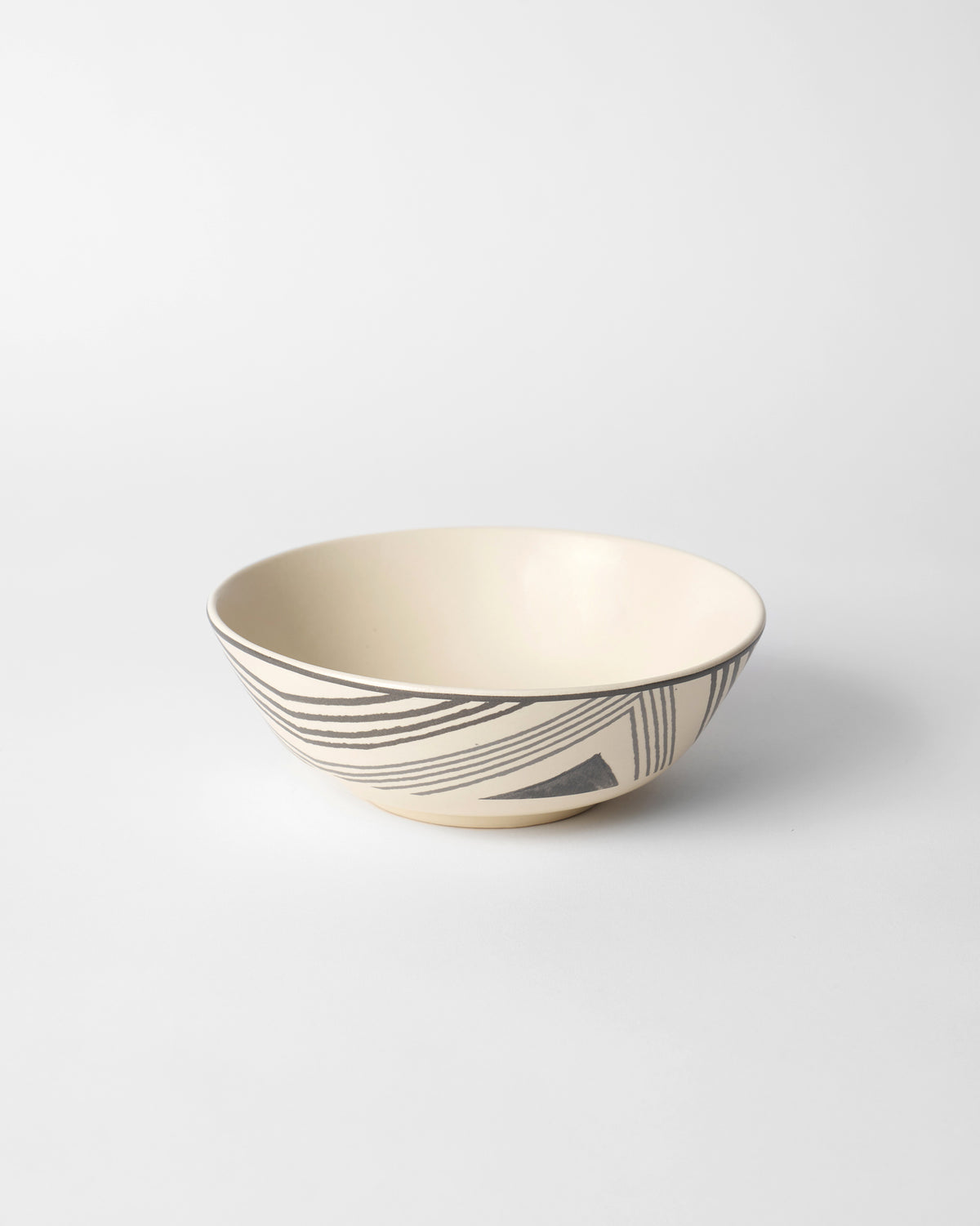 Indus Curry Bowl in cream with black stroke lines and a triangle motif.