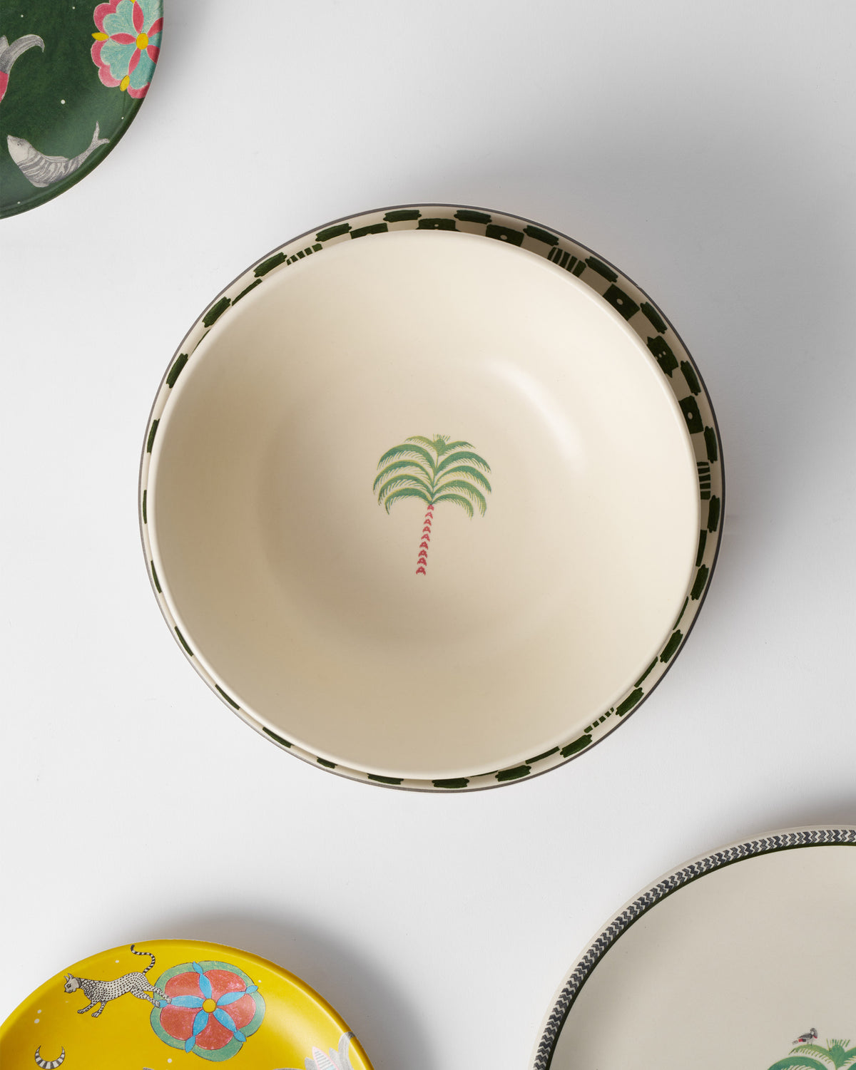 Indus Curry Bowl from above, with a checkered green rim and palm inside.