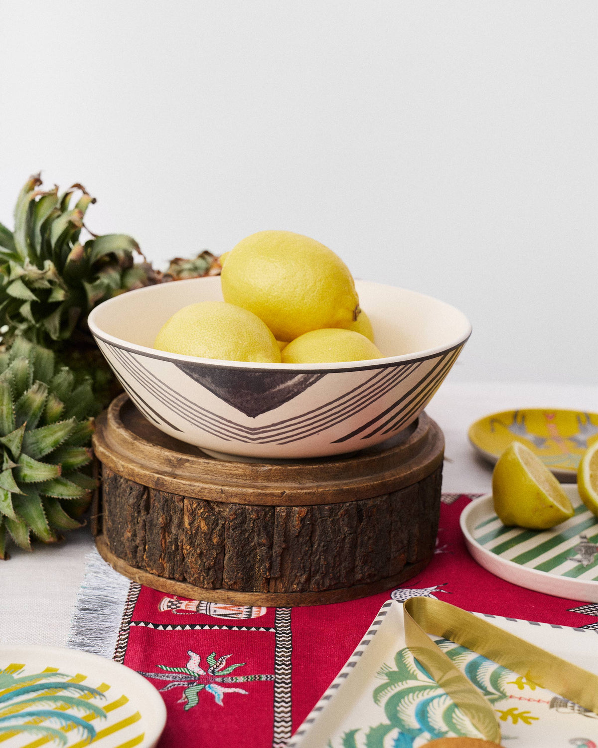 Indus Curry Bowl on a wooden stand, holding lemons.