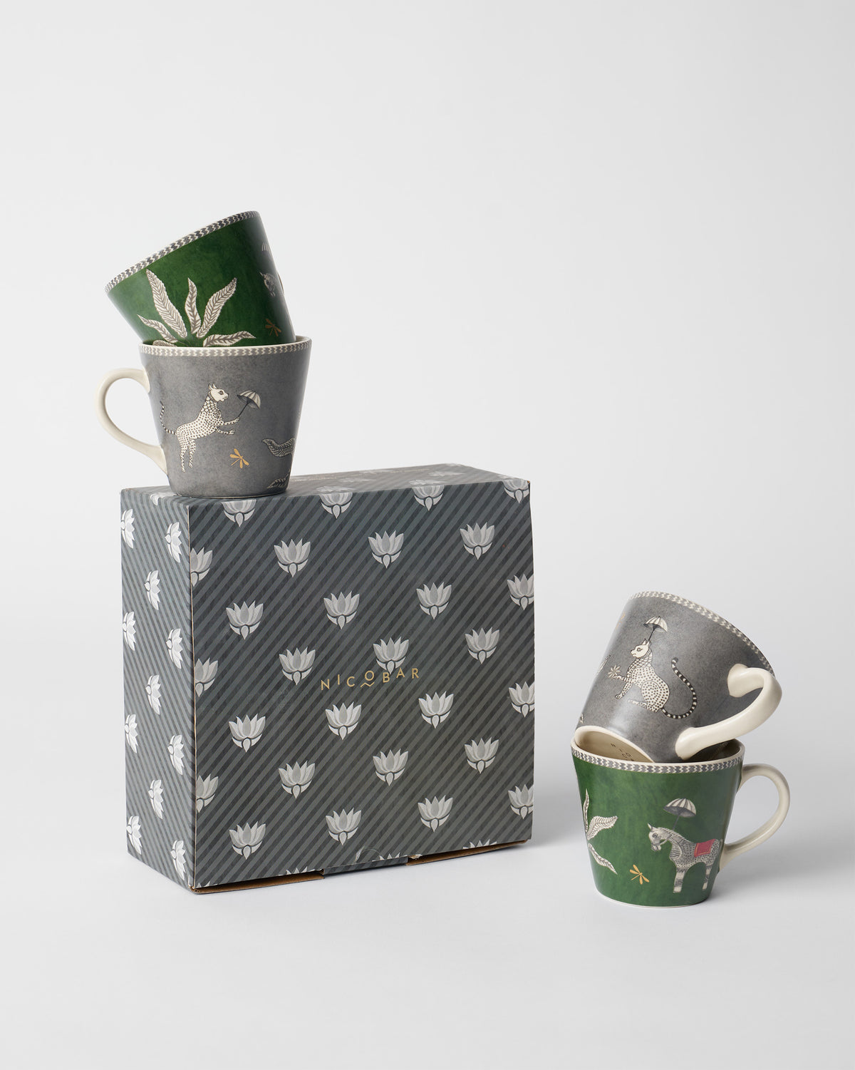 Indus espresso mugs beside a striped Nicobar gift box.