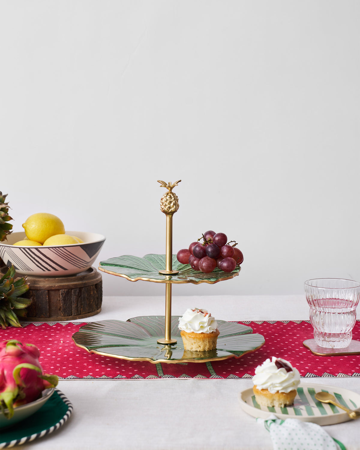 Phool Cake Stand shown in a table setting with its two green tiers.