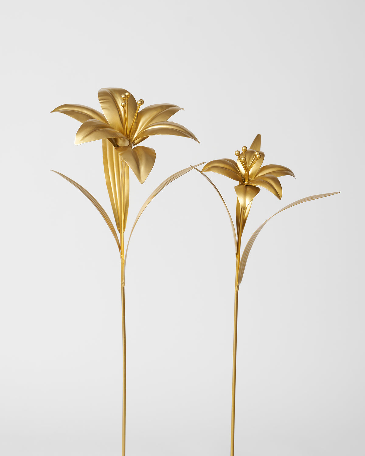 Pair of gold Lily Accent Pieces on slender stems.