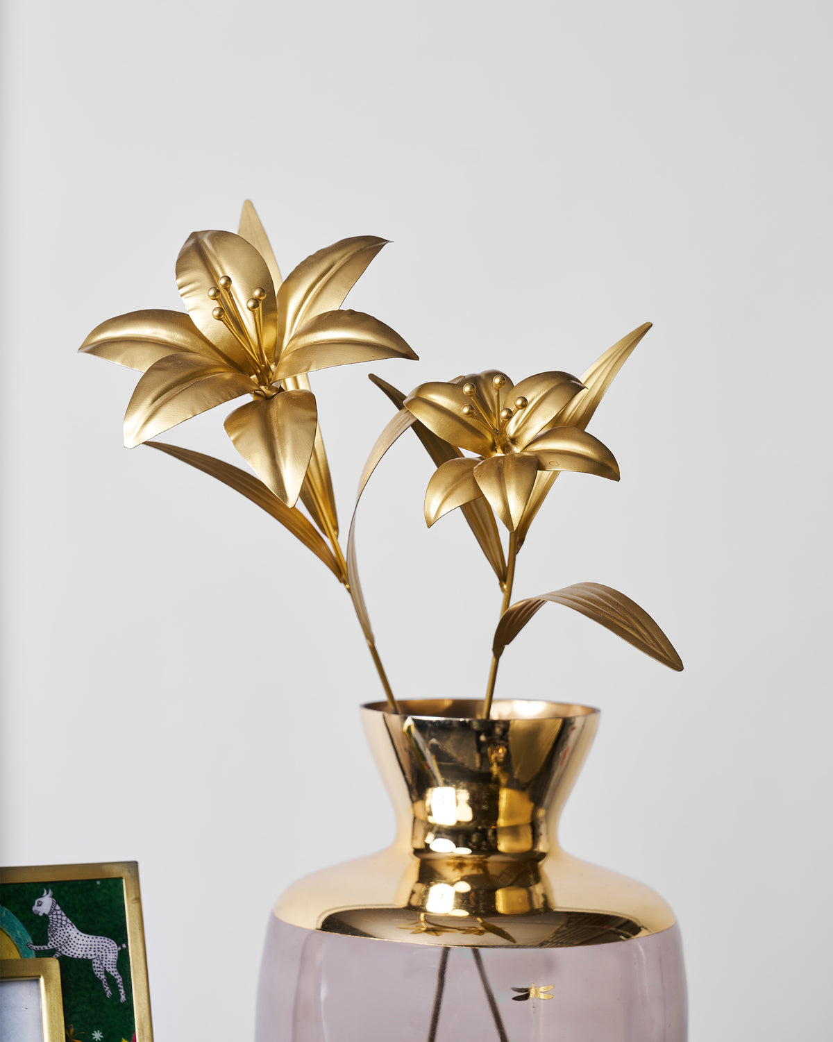 Gold Lily Accent Pieces arranged in a gold-rimmed vase.