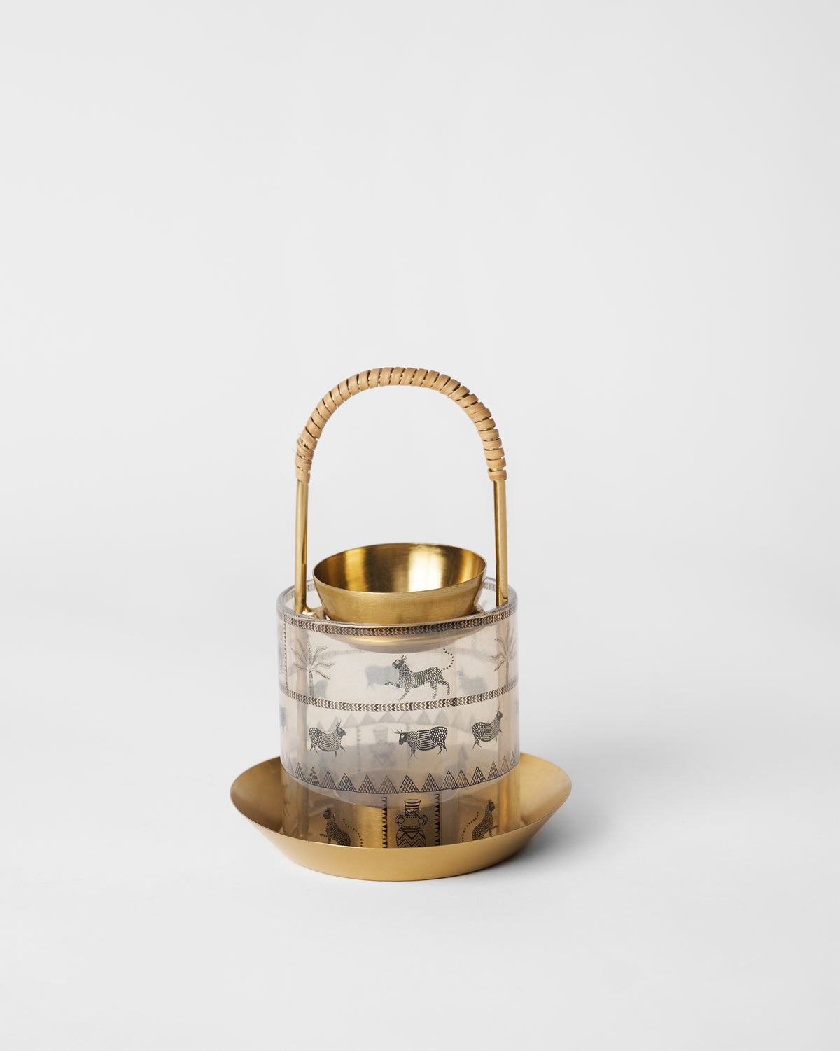 Indus diffuser with gold base, motif glass chimney, and rattan handle.
