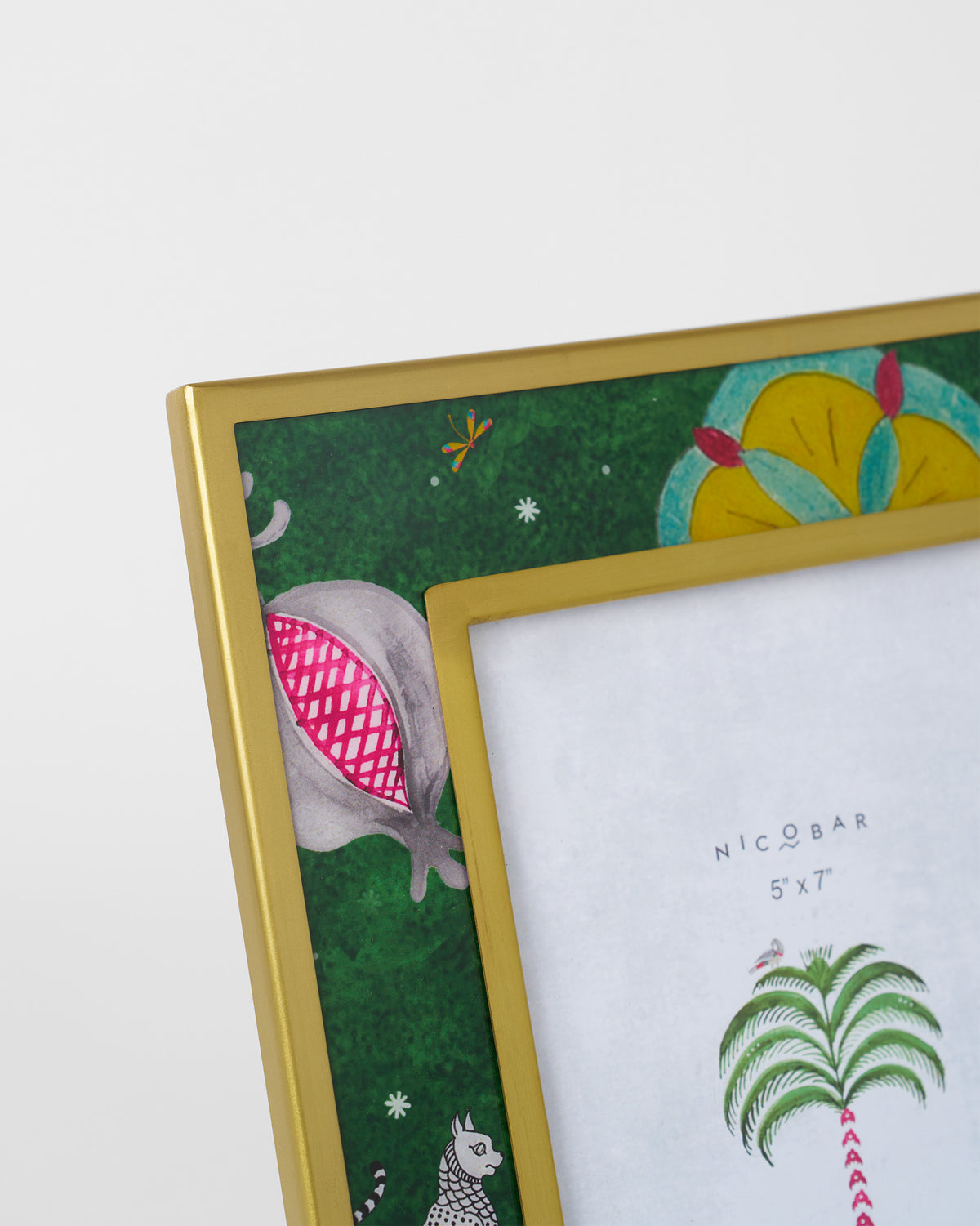 Close-up of an Anara photo frame showing a pomegranate and floral motifs.