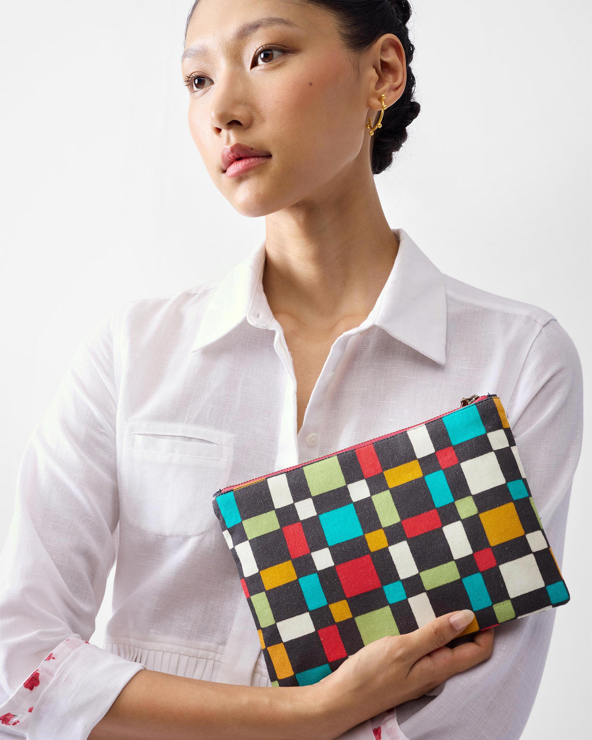 Multicolor Abstract Heart Pouch with a geometric print held against a white shirt.