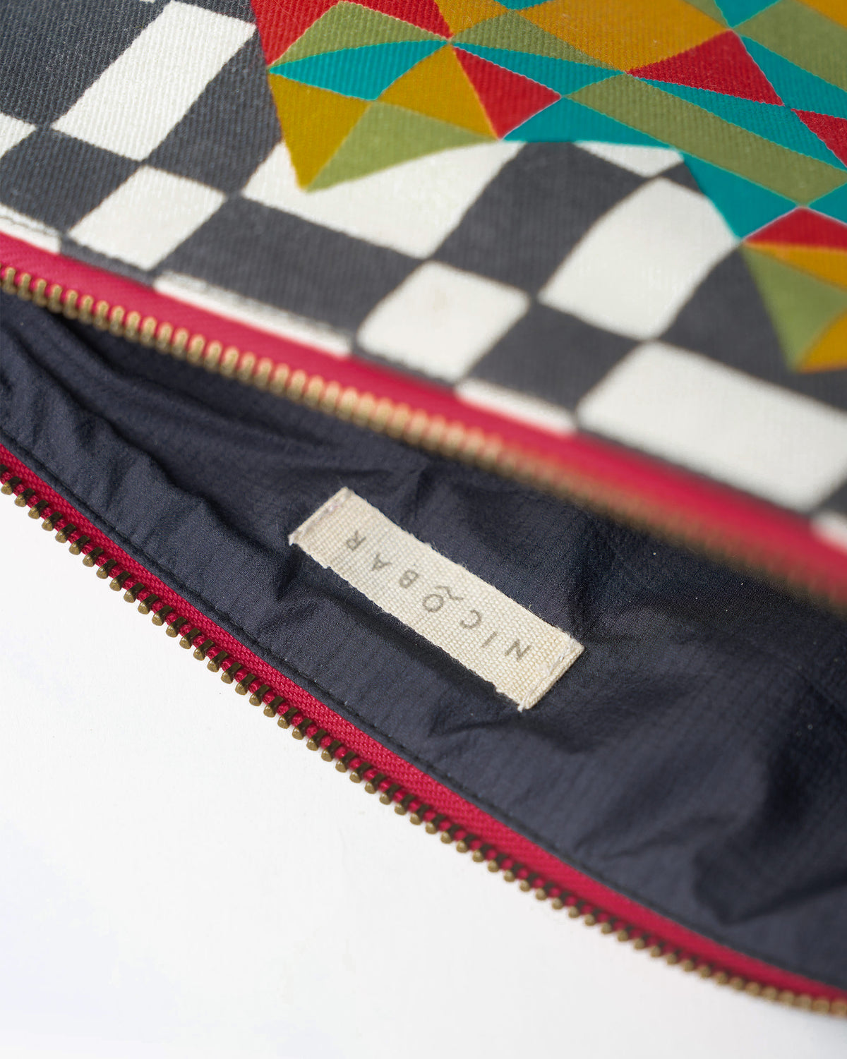 Open multicolor Abstract Heart Pouch showing the dark lining and Nicobar label.