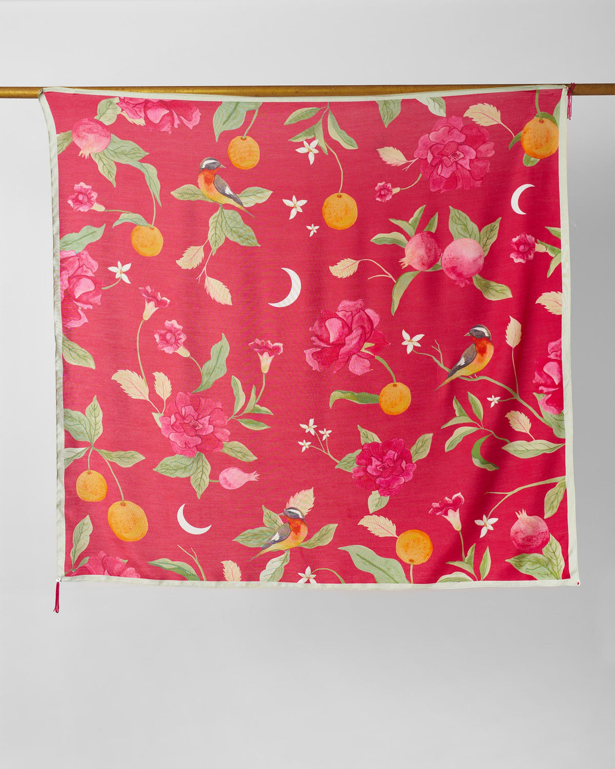 Dusk Garden scarf hung flat, showing birds, roses and crescent moons on red-pink.