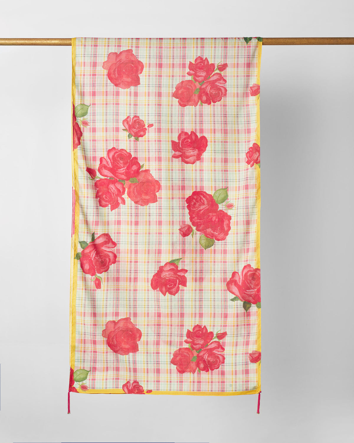 Ruhm scarf hung flat, showing red roses across a pink and yellow check.