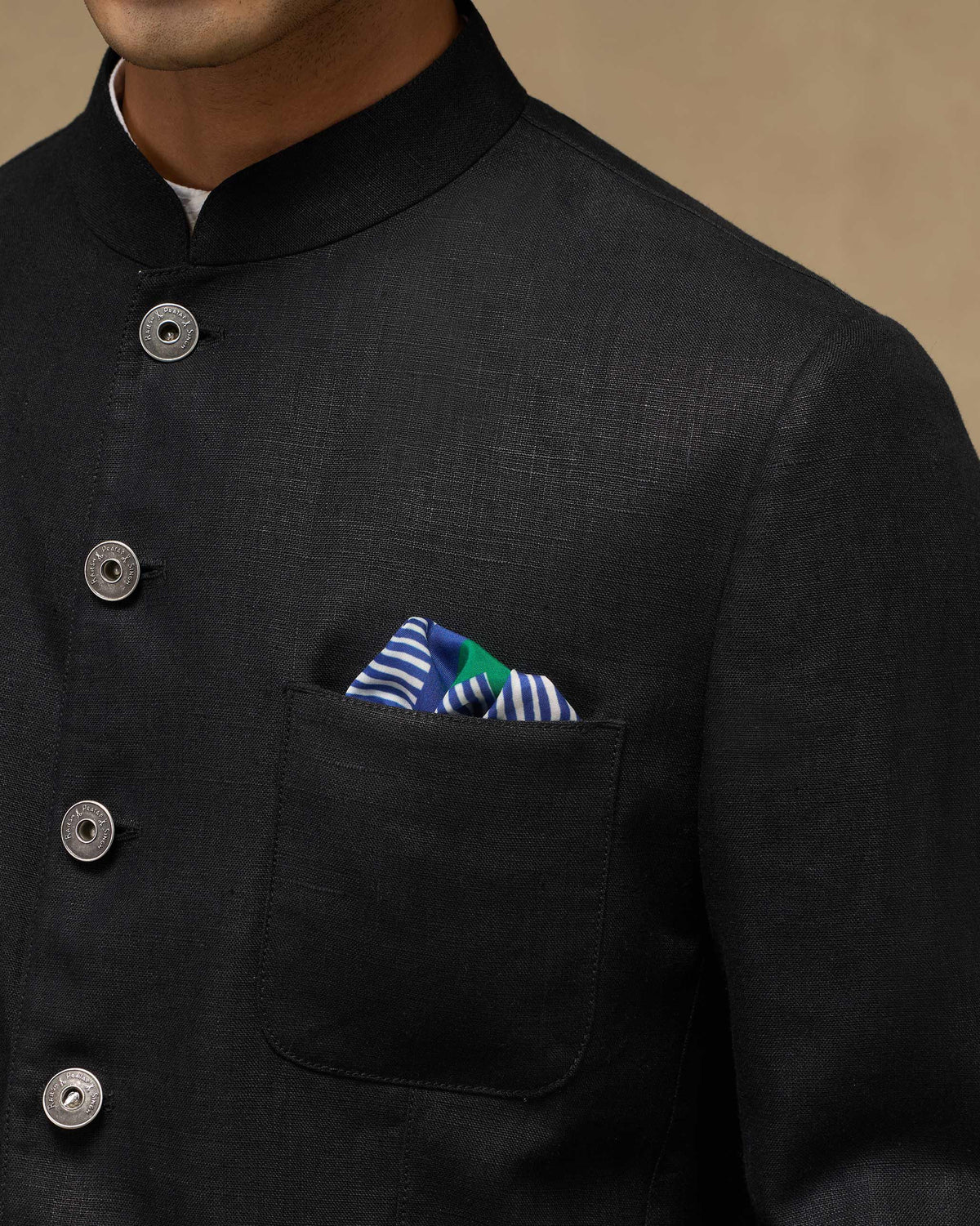 Blue and green Baagh Pocket Square worn in a jacket pocket.