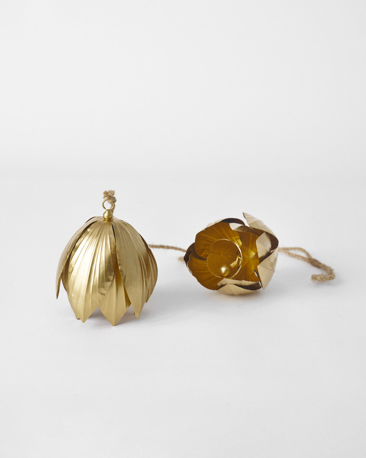 Pair of gold lotus bells, one tipped open to show the spherical clapper.