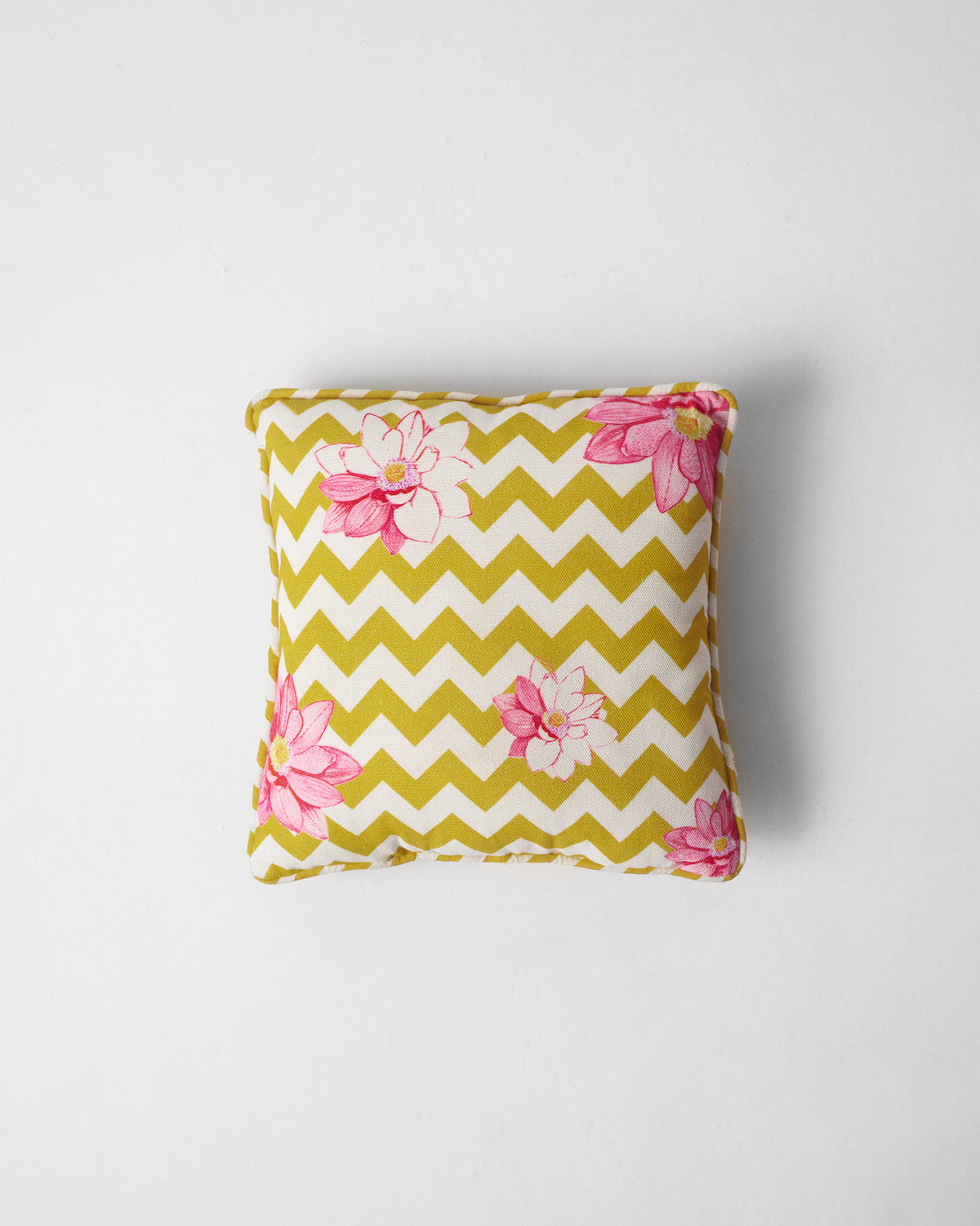 Chevron Lotus Car Cushion in yellow chevrons with pink lotus flowers.