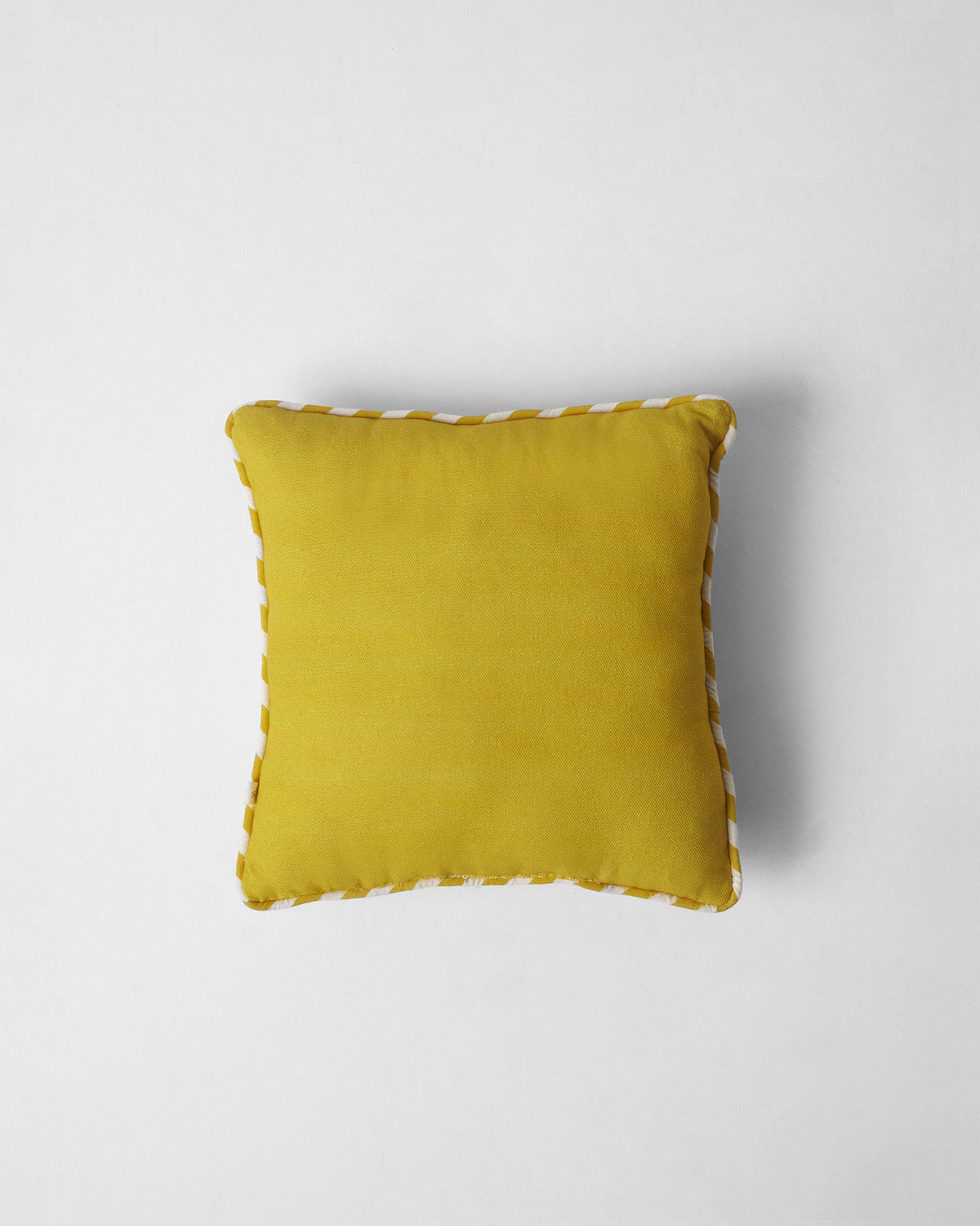 Chevron Lotus Car Cushion in plain yellow with cream piping.