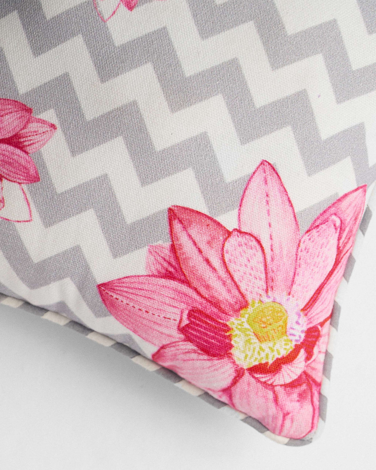Close-up of Chevron Lotus Car Cushion showing a pink lotus on grey chevrons.