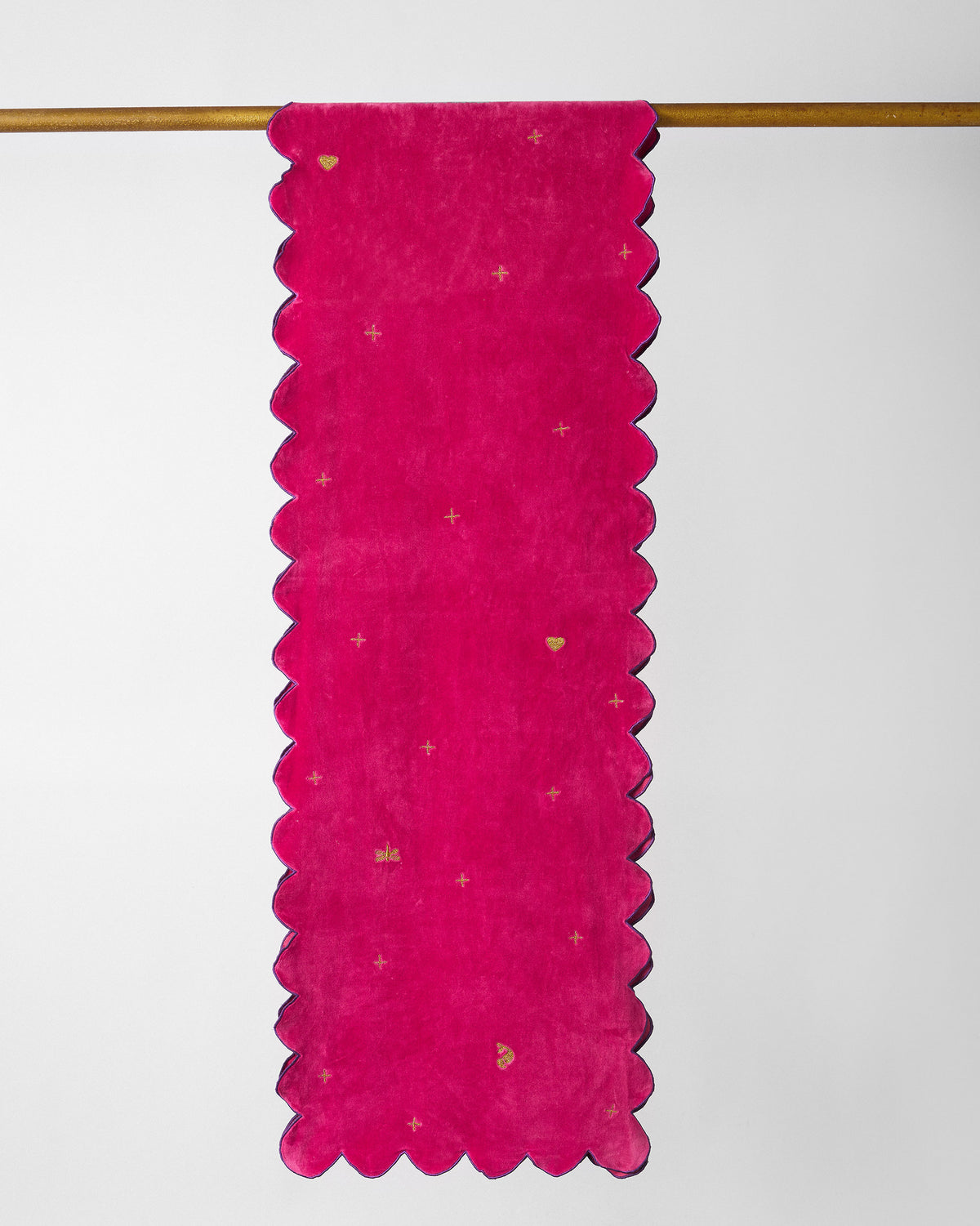 Dream table runner in pink with scalloped edges and small gold hearts and stars.