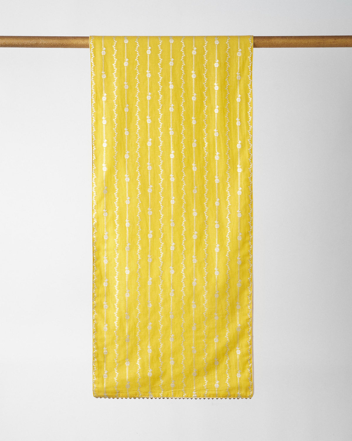 Yellow Float runner with white vertical motif stripes, hanging on a rod.