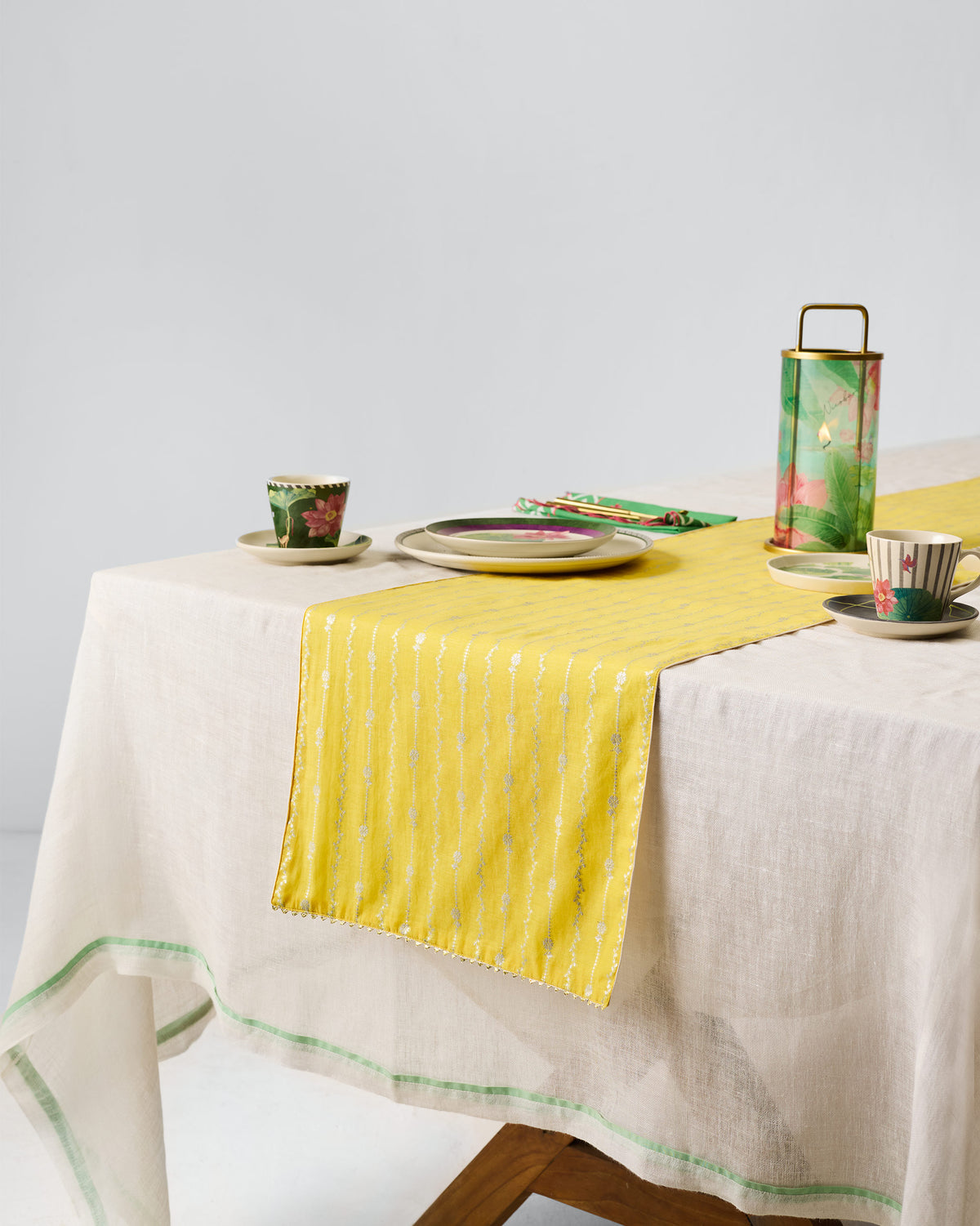 Yellow Float runner laid across a white linen table.