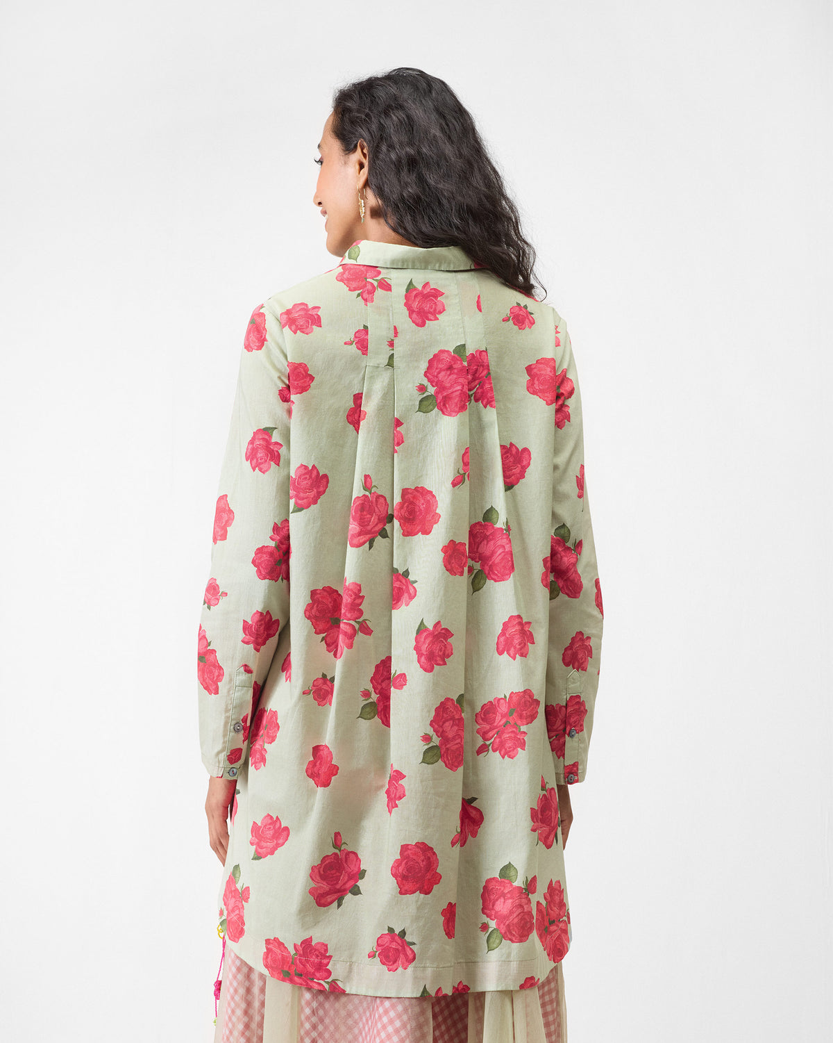 Back of a mint High Low Shirt with rose print and flared pleats.
