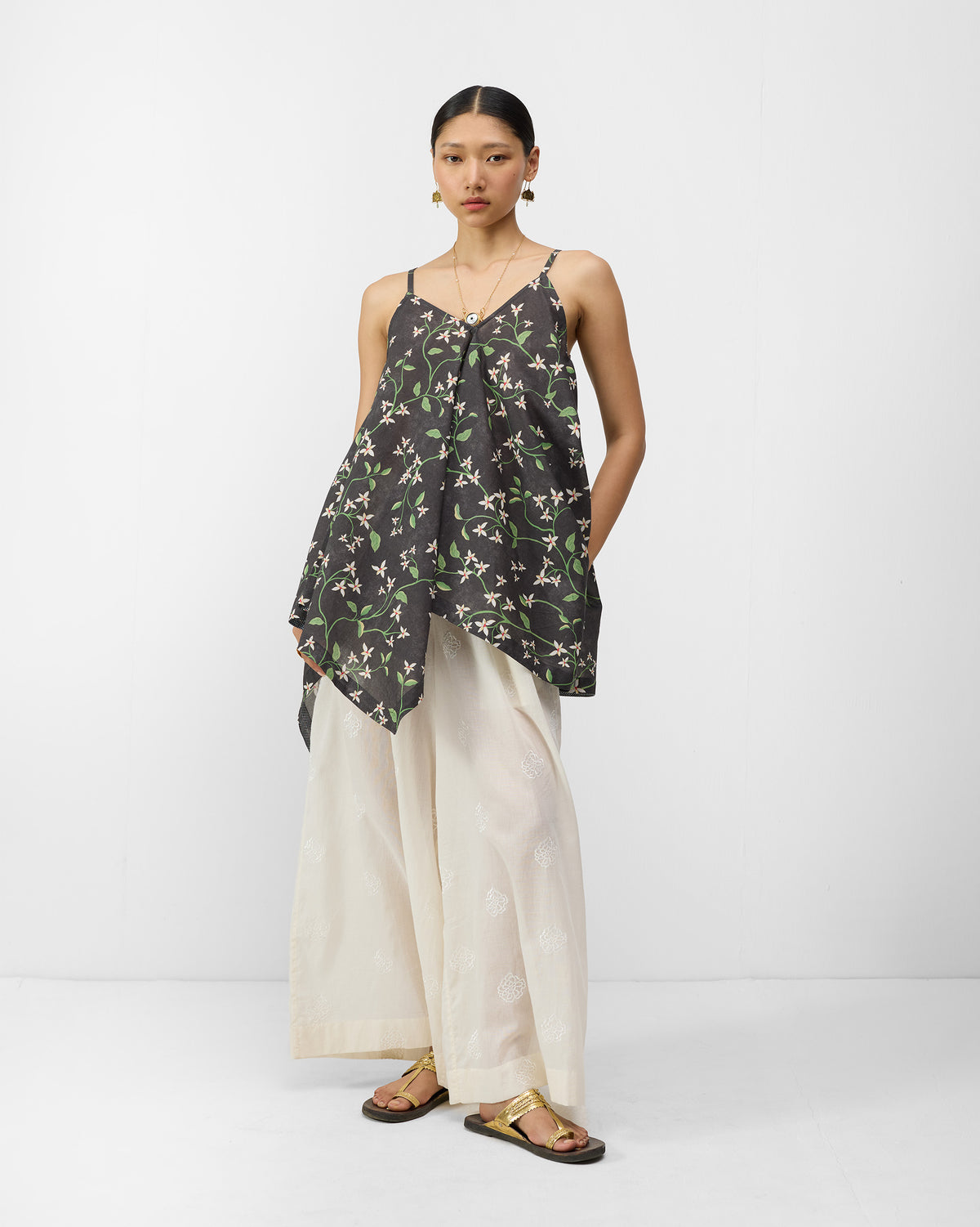 Person wearing a charcoal jasmine-print Handkerchief Top with a pointed hem.