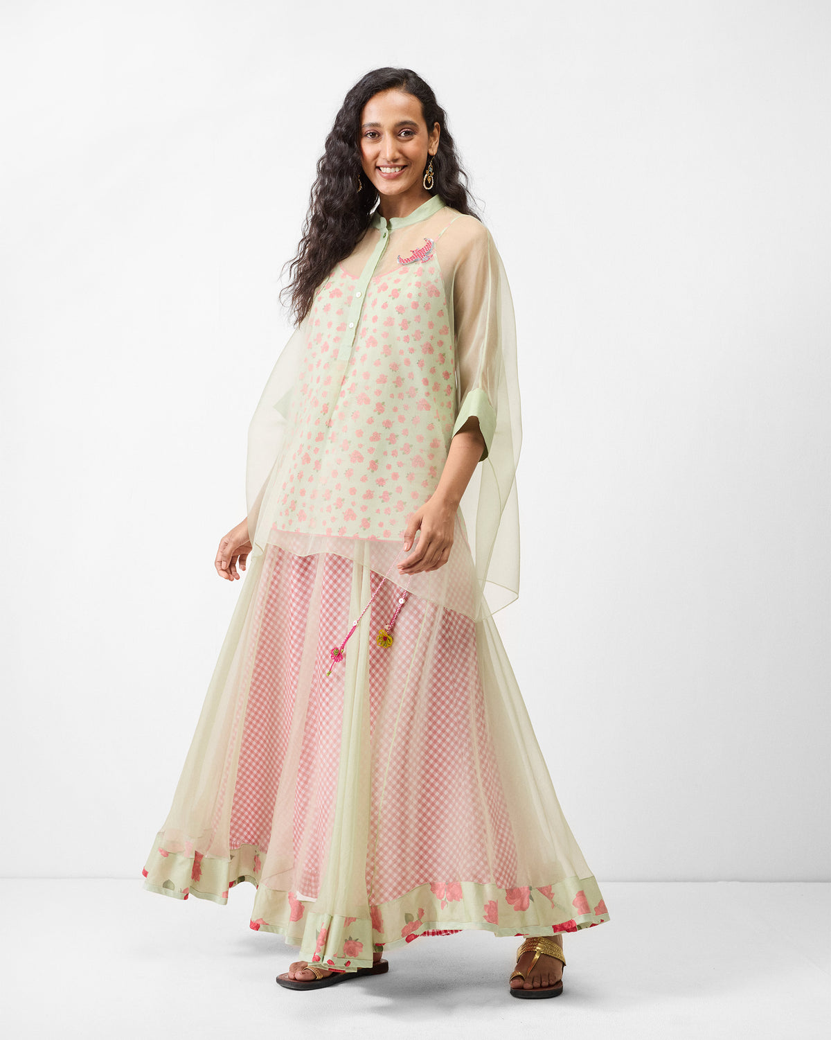 Person wearing a sheer mint Jaisalmer shirt with slip and a bird embroidery.