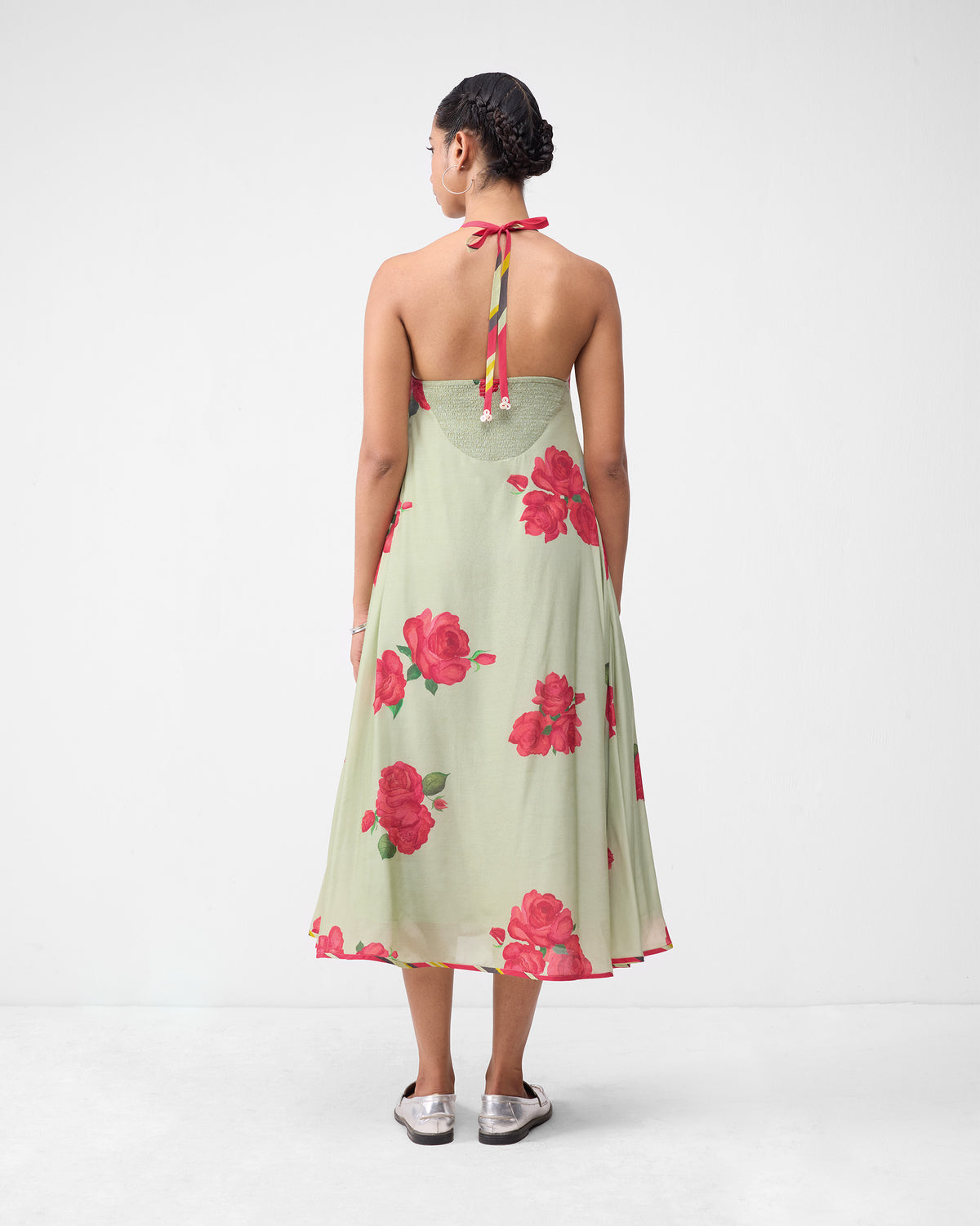 Back of a mint watermelon print scoop back dress with a deep scoop and tied straps.