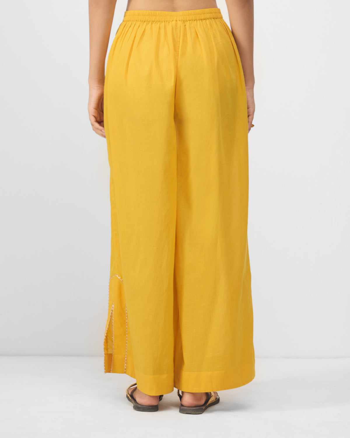 Back of turmeric yellow Ayat pyjamas with an elastic waist.
