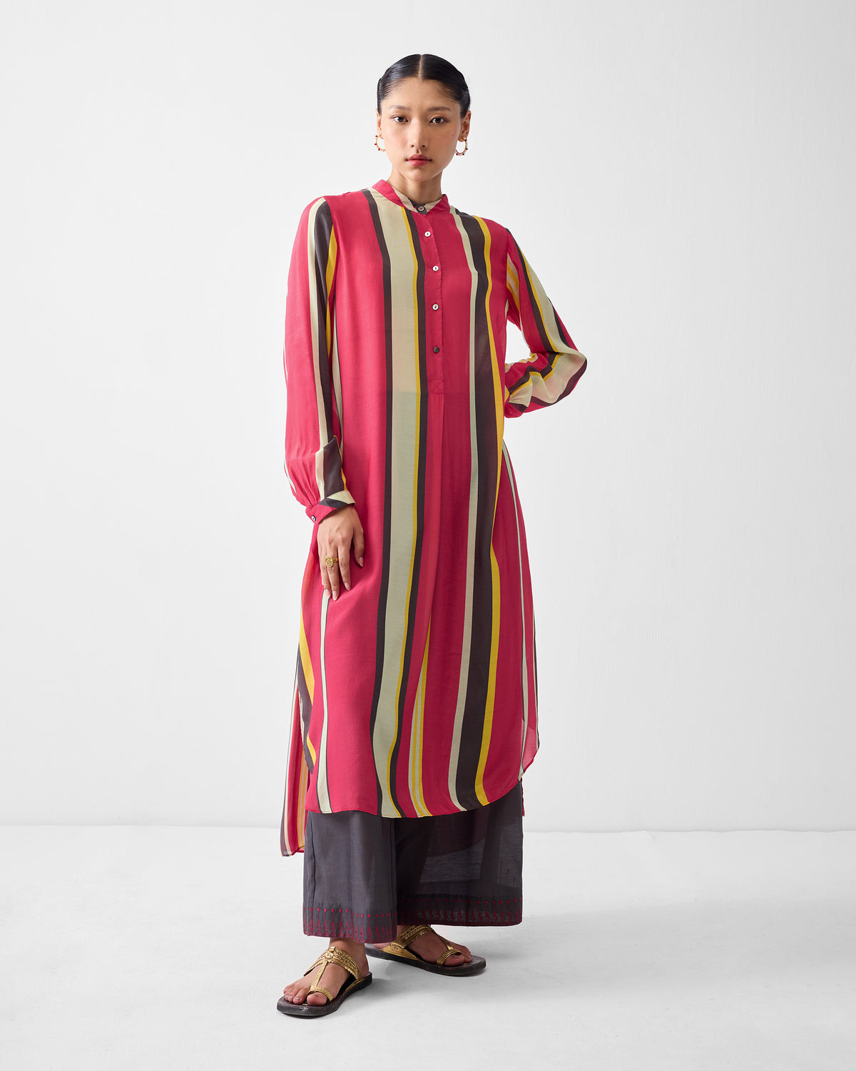 Person wearing a striped smocked back kurta with a mandarin collar.