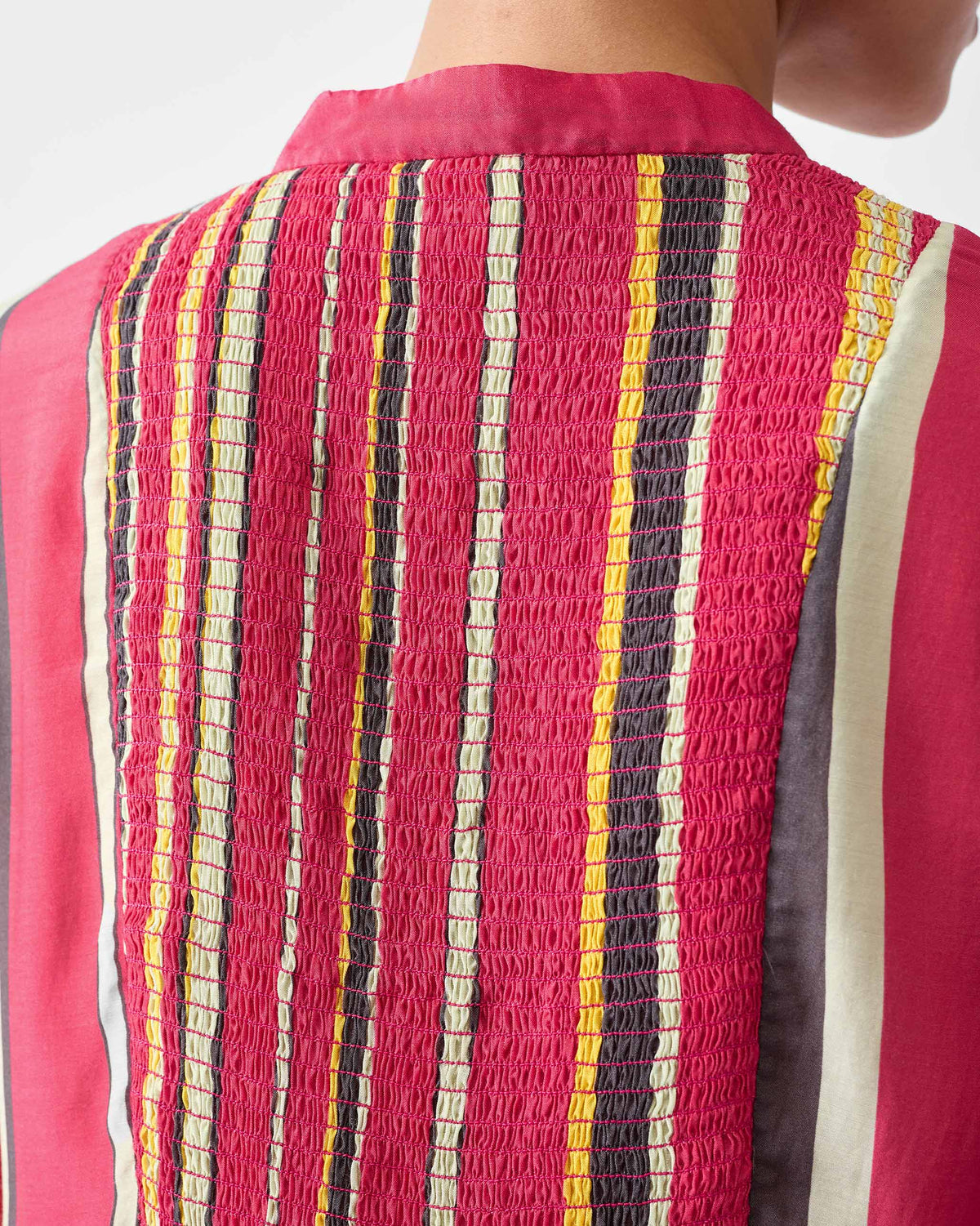 Close-up of smocking on a multicolor striped kurta.
