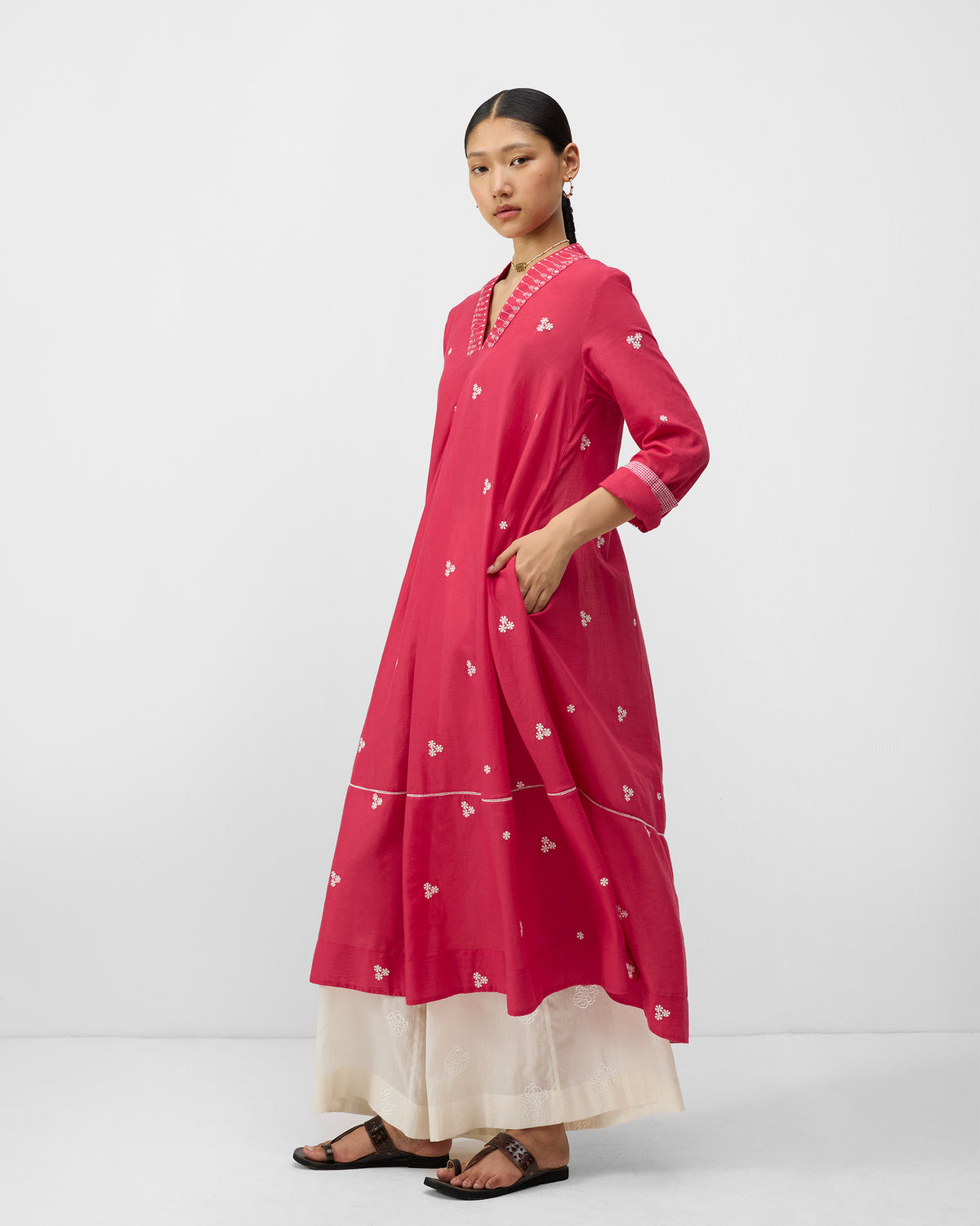 Three-quarter view of a watermelon pink Banko kurta with ivory embroidery.