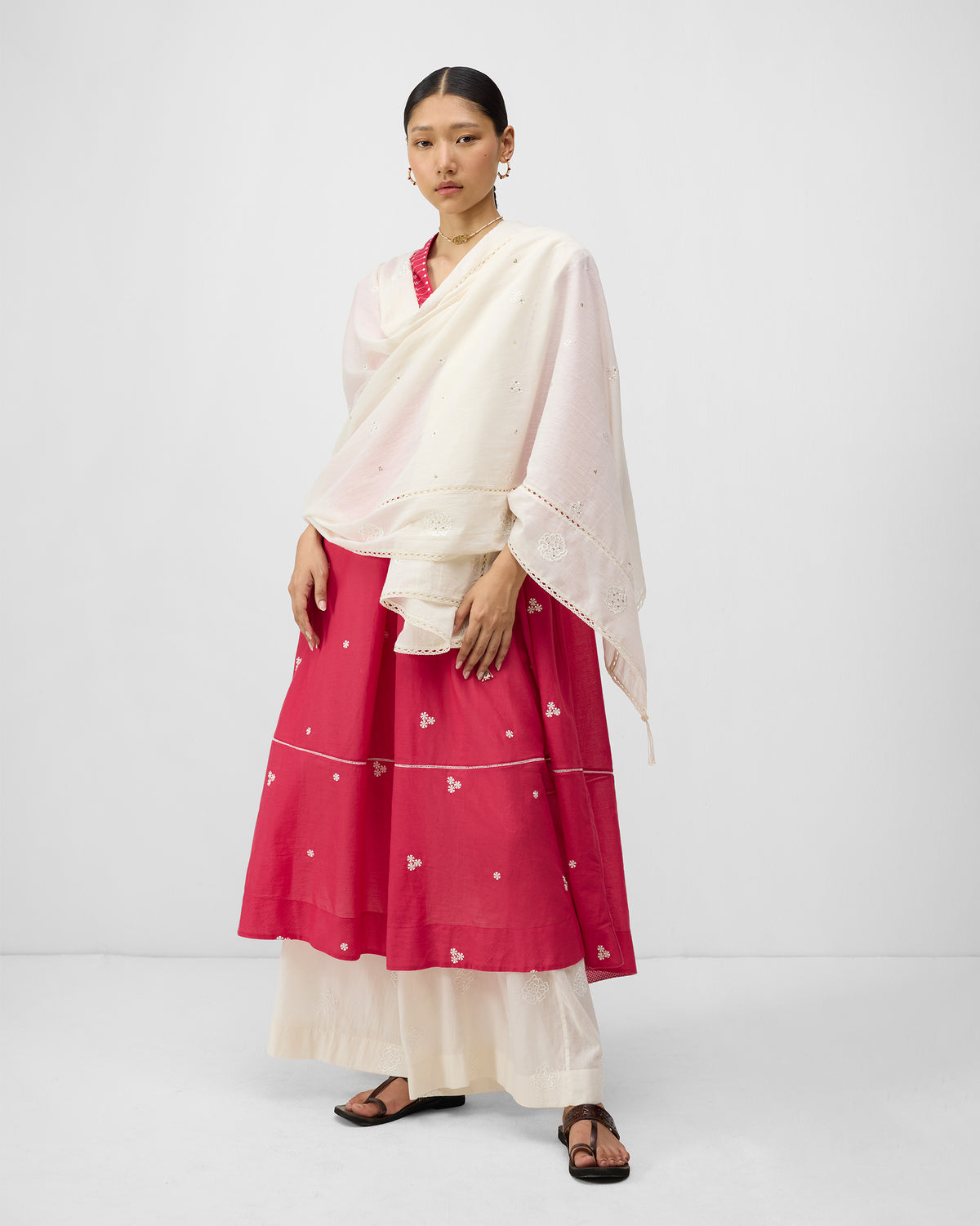 Person wearing a watermelon pink Banko kurta with an ivory embroidered dupatta.