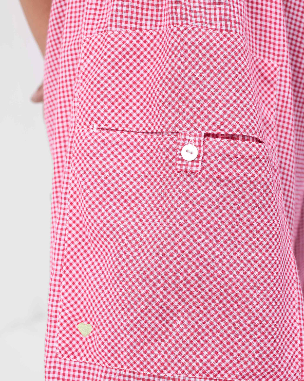 Close-up of Jaisalmer Pants check pocket with a button tab and embroidered heart.