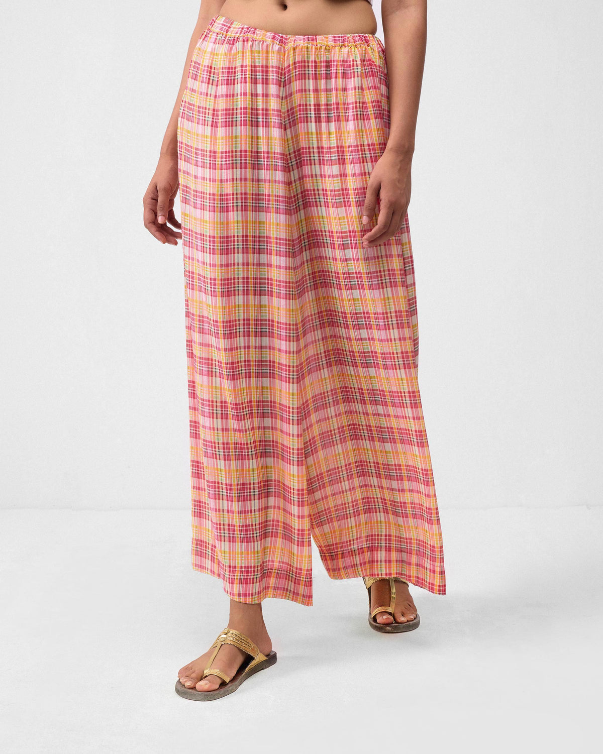 Person wearing multicolor check Classic Pyjama pants with a gathered waist.