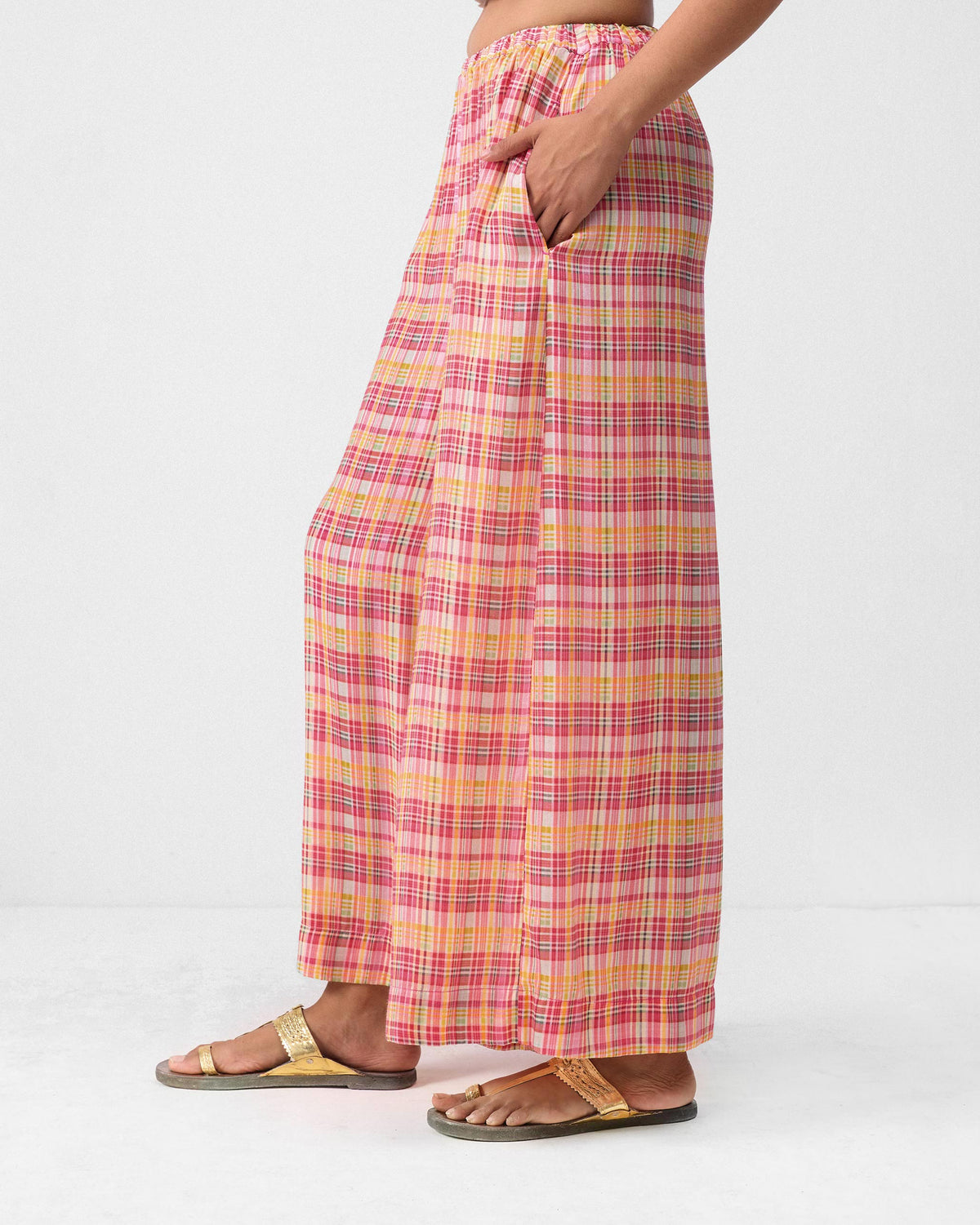 Side view of multicolor check Classic Pyjama pants with a hand in the pocket.