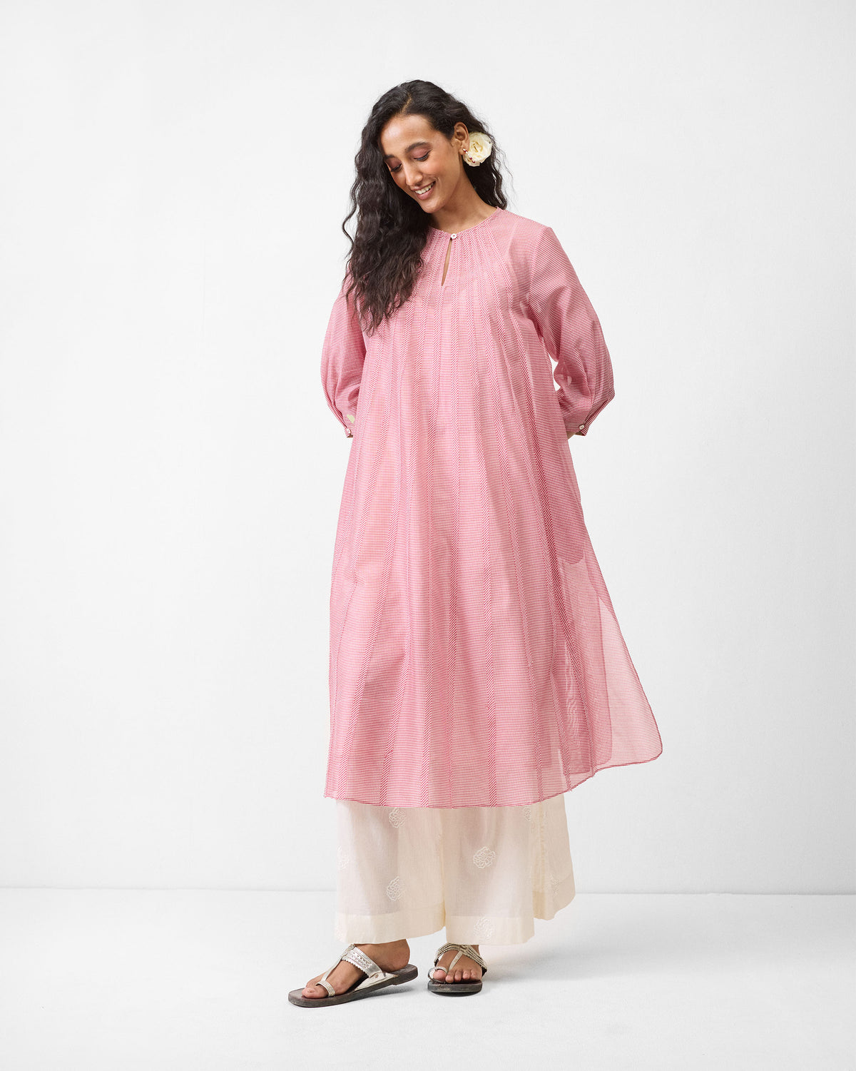 Person wearing a pink Pattaya kurta with a keyhole neck and puff sleeves.