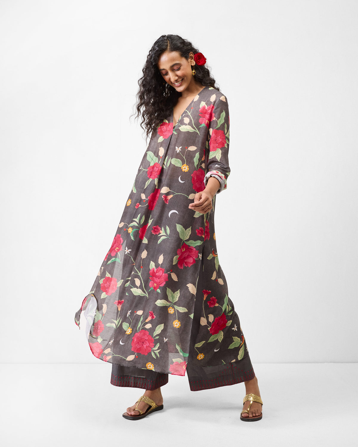 Person wearing a charcoal kurta with a red watermelon floral print.