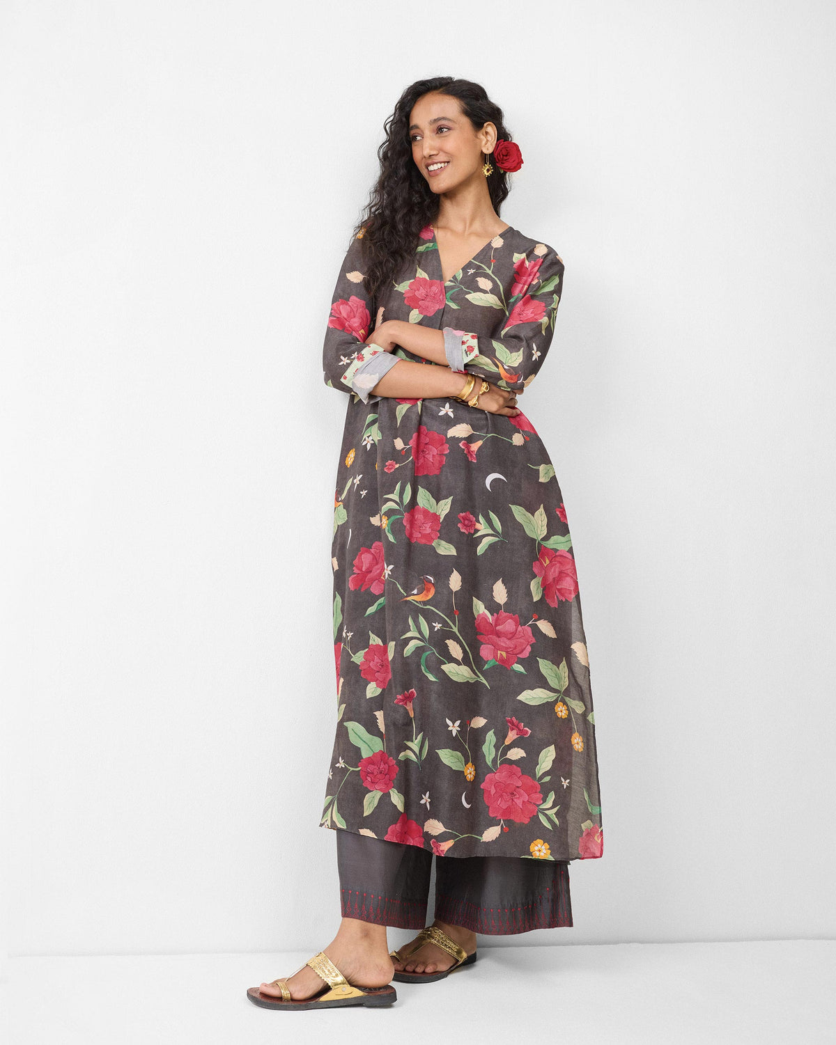 Person wearing a charcoal kurta with red peony print.