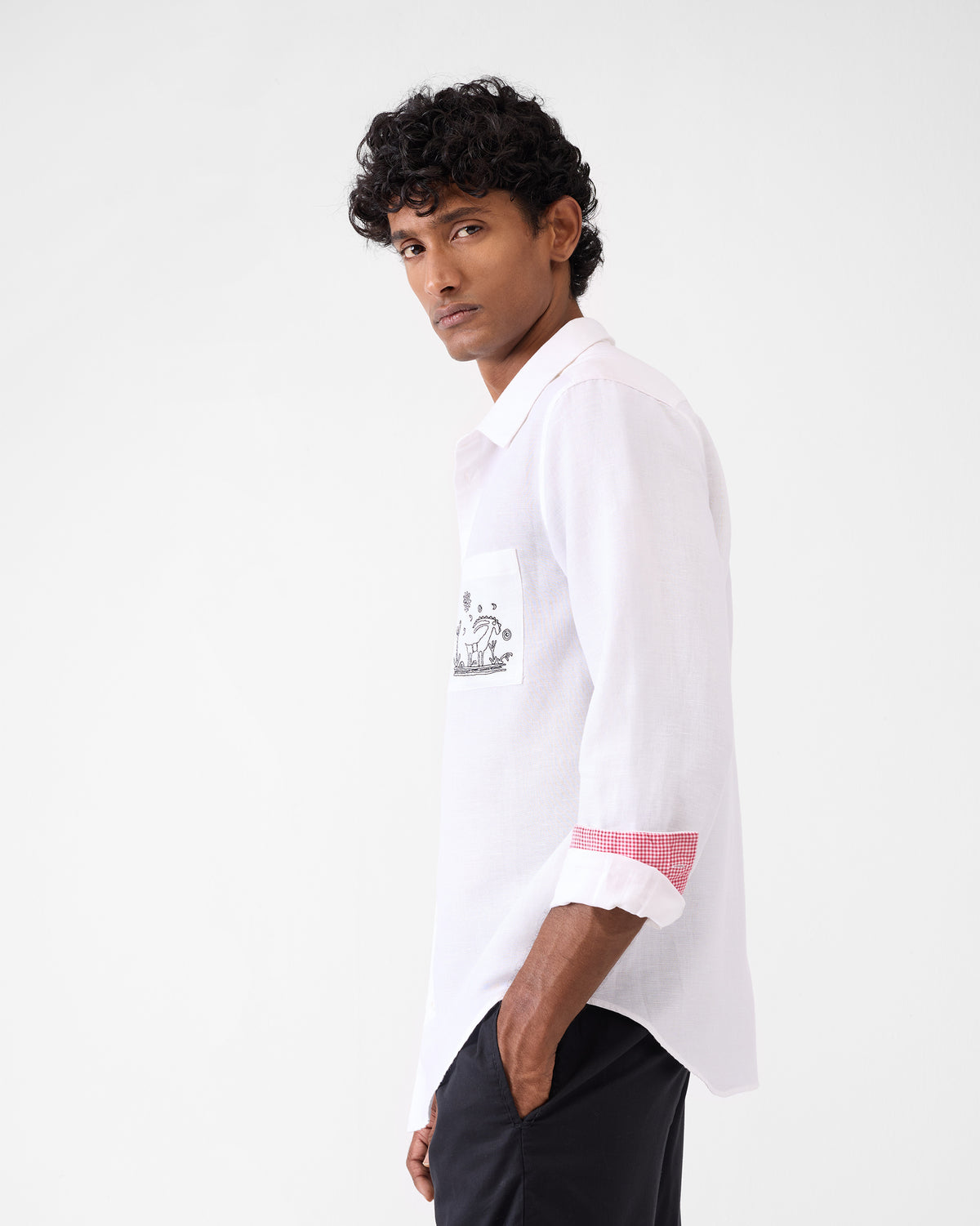 Side view of a white Musafir Pocket Shirt with pocket embroidery.