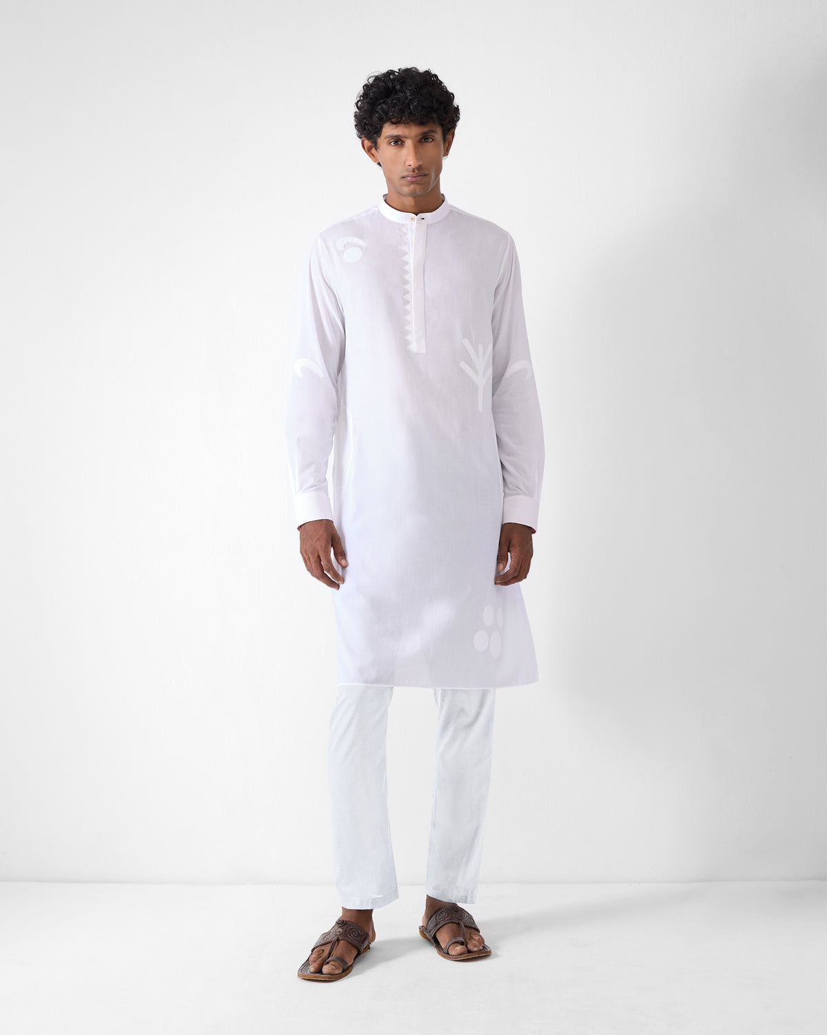 Person wearing a white Neckband Kurta with tonal appliqué motifs and a band collar.