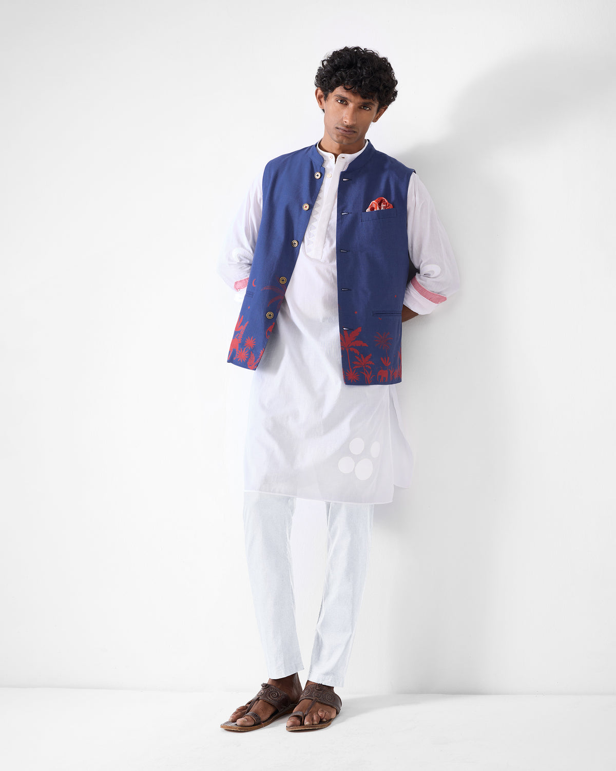 Person wearing a white Neckband Kurta styled under a navy Nehru jacket.