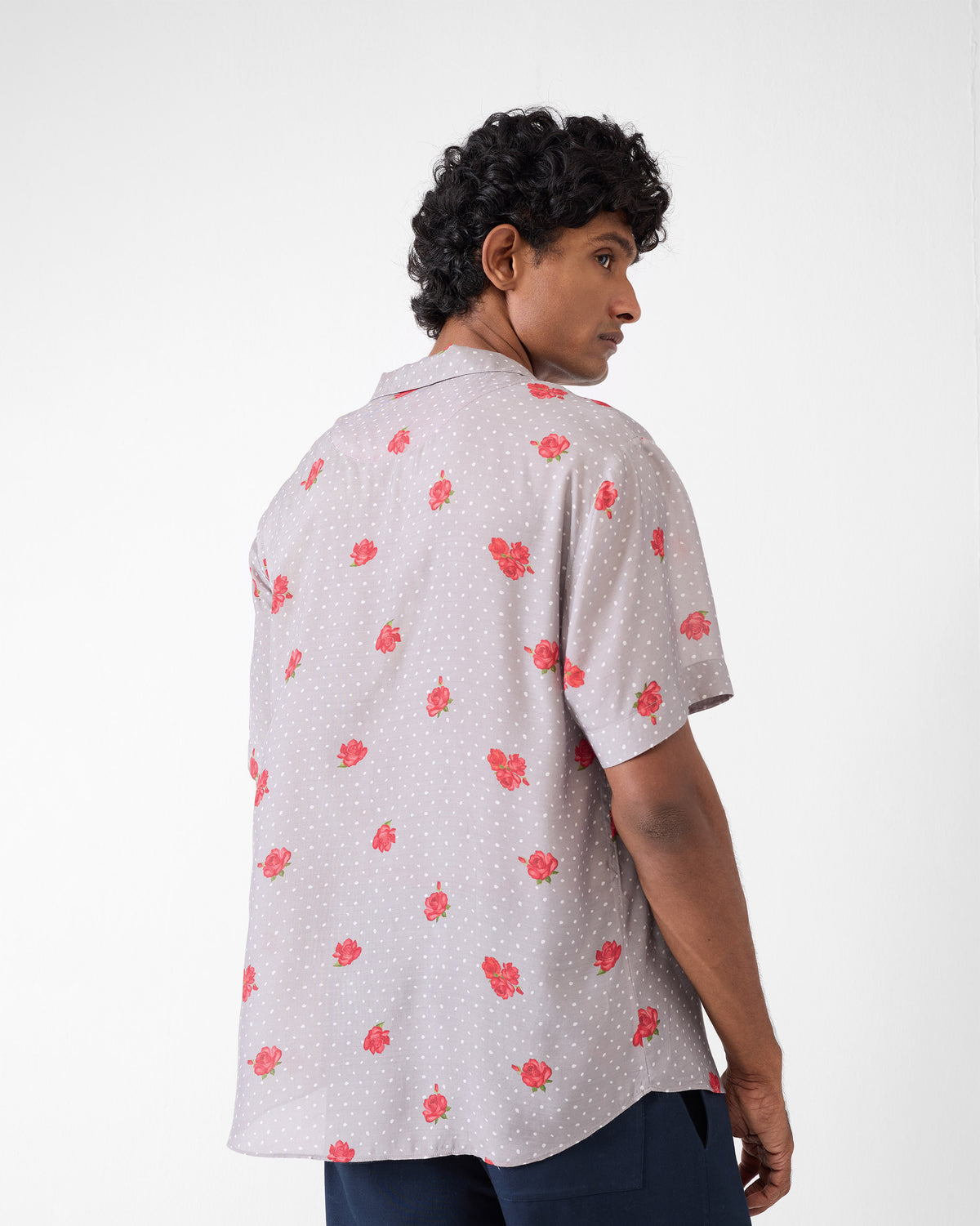 Back of a charcoal Mistari Shirt with red floral print.
