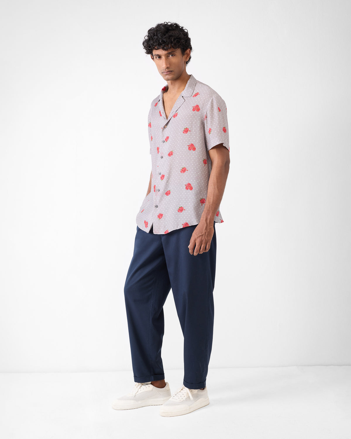 Person wearing a charcoal Mistari Shirt with red floral print, shown full length.