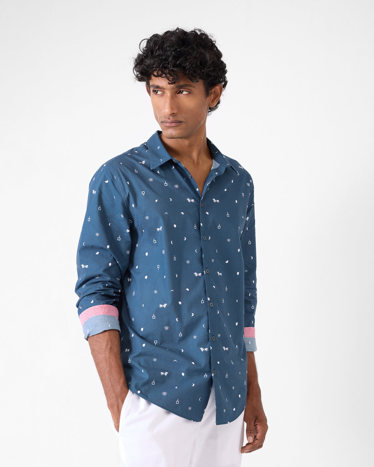Person wearing a navy Hakuna shirt with pink contrast cuff lining.