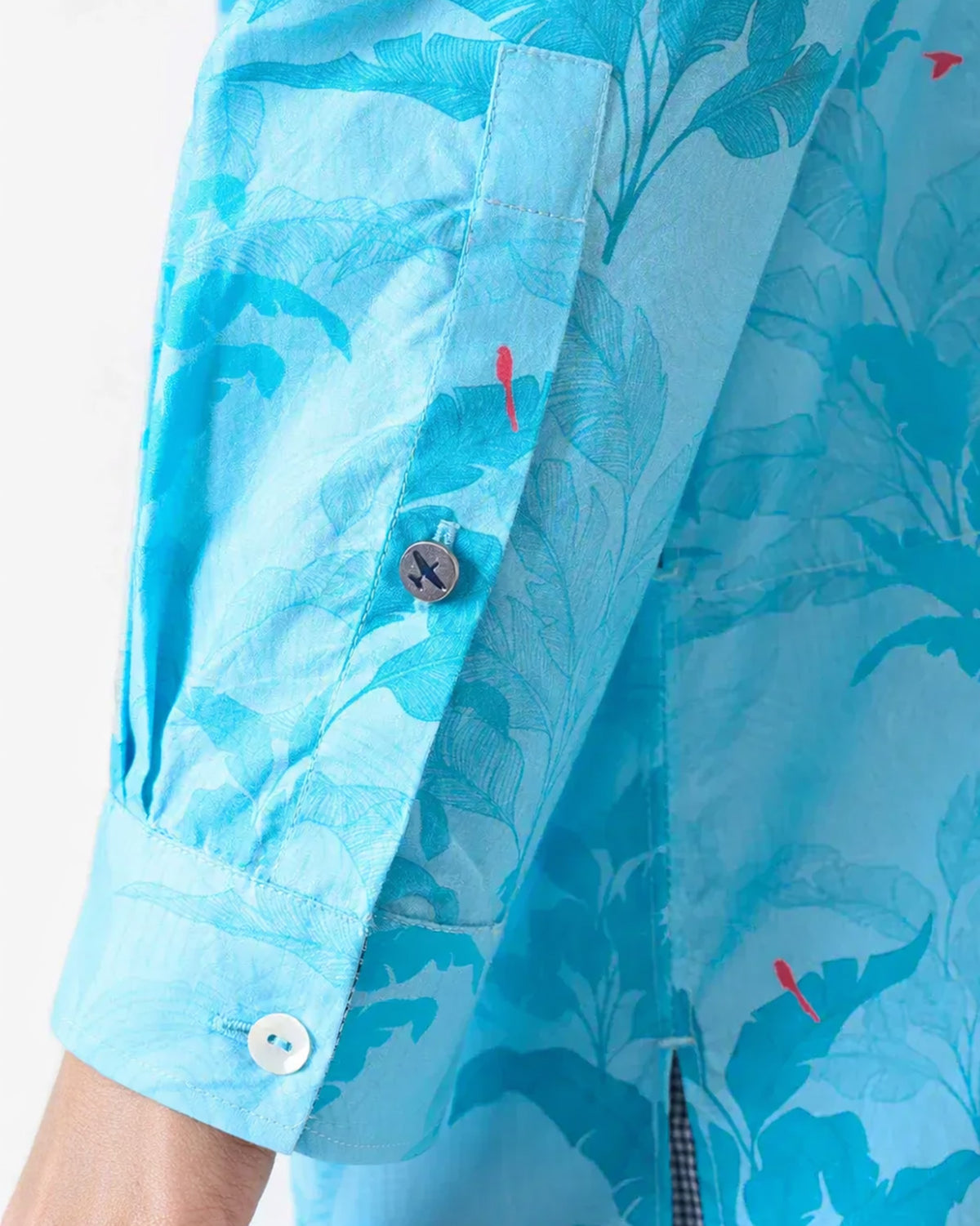 Close-up of a light blue Bouquet Kurta sleeve showing the airplane button.
