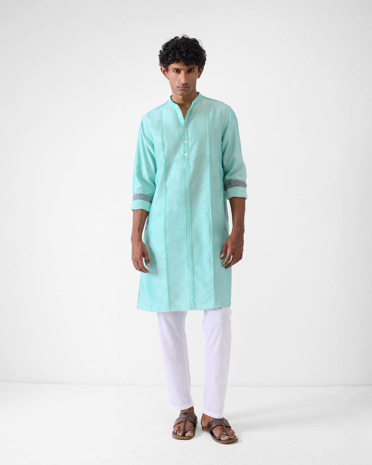 Person wearing an aqua Naaz kurta with contrast cuff lining.