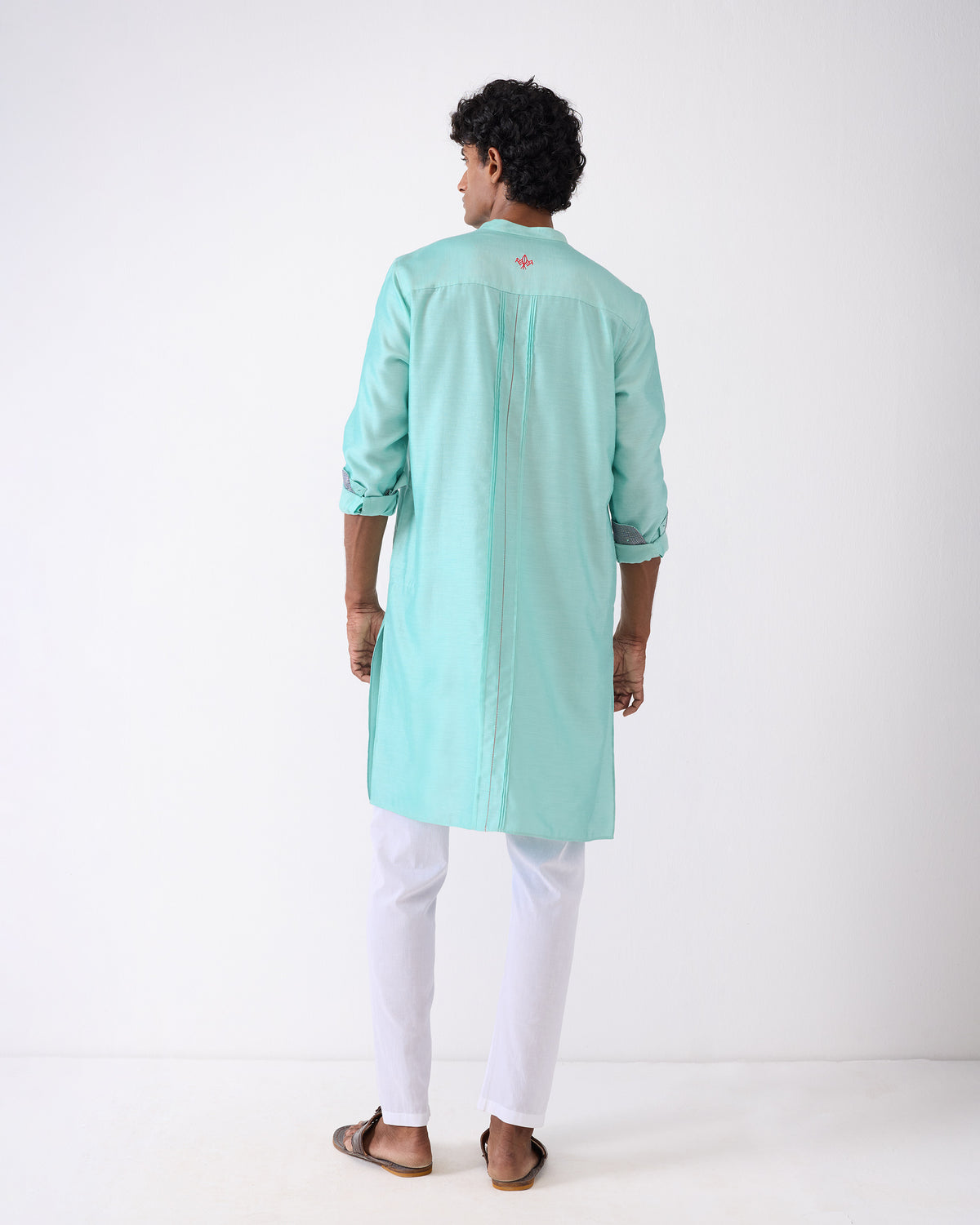 Back of an aqua Naaz kurta with a red bird at the yoke.