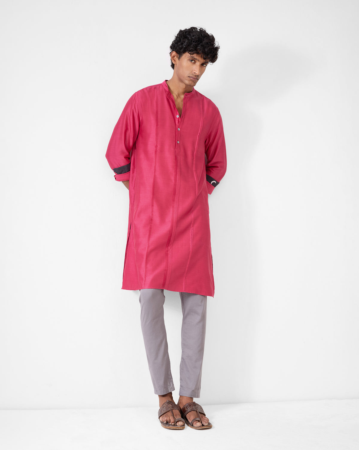 Person wearing a watermelon Naaz kurta with contrast cuff lining.