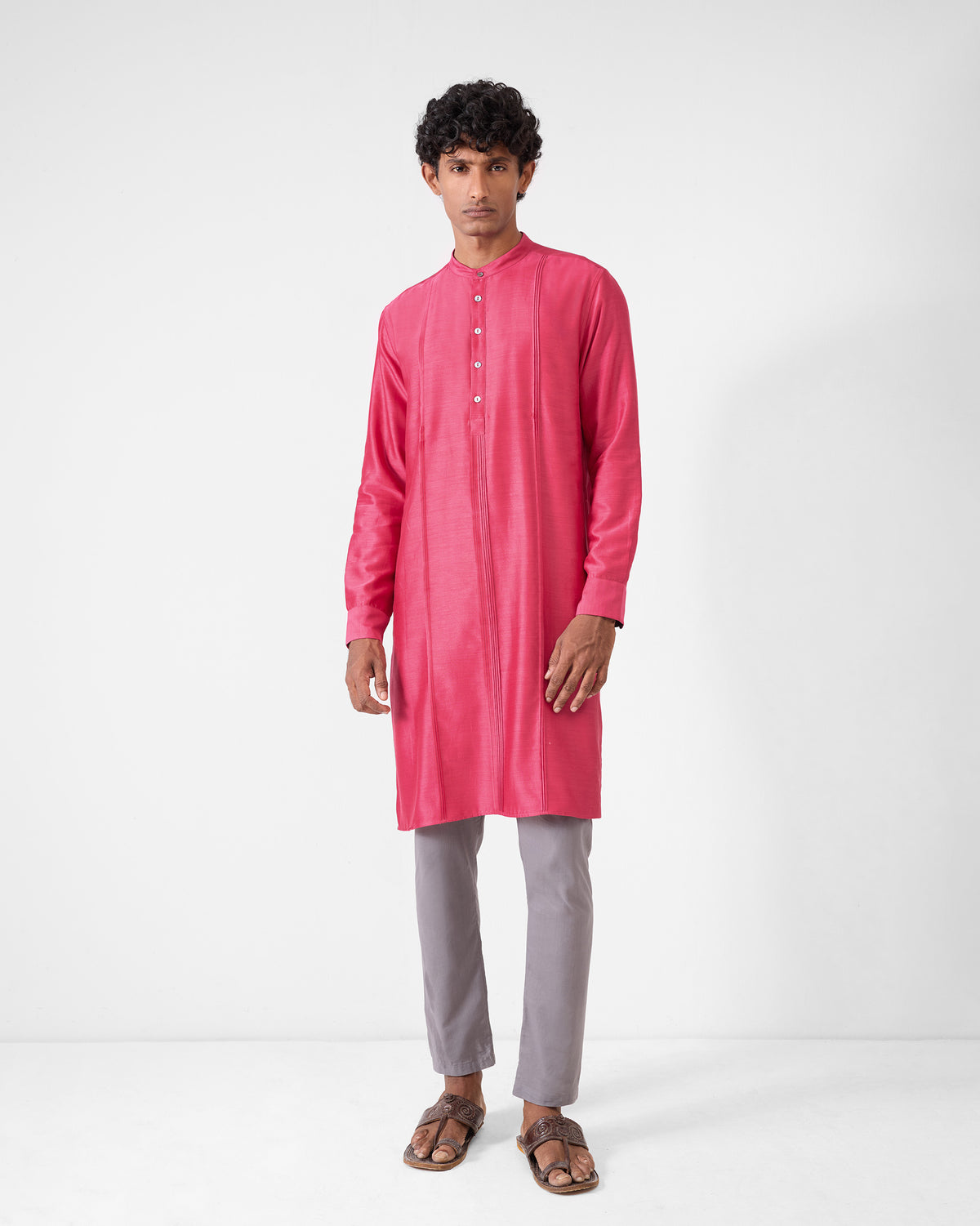 Person wearing a watermelon Naaz kurta with front panel seams.