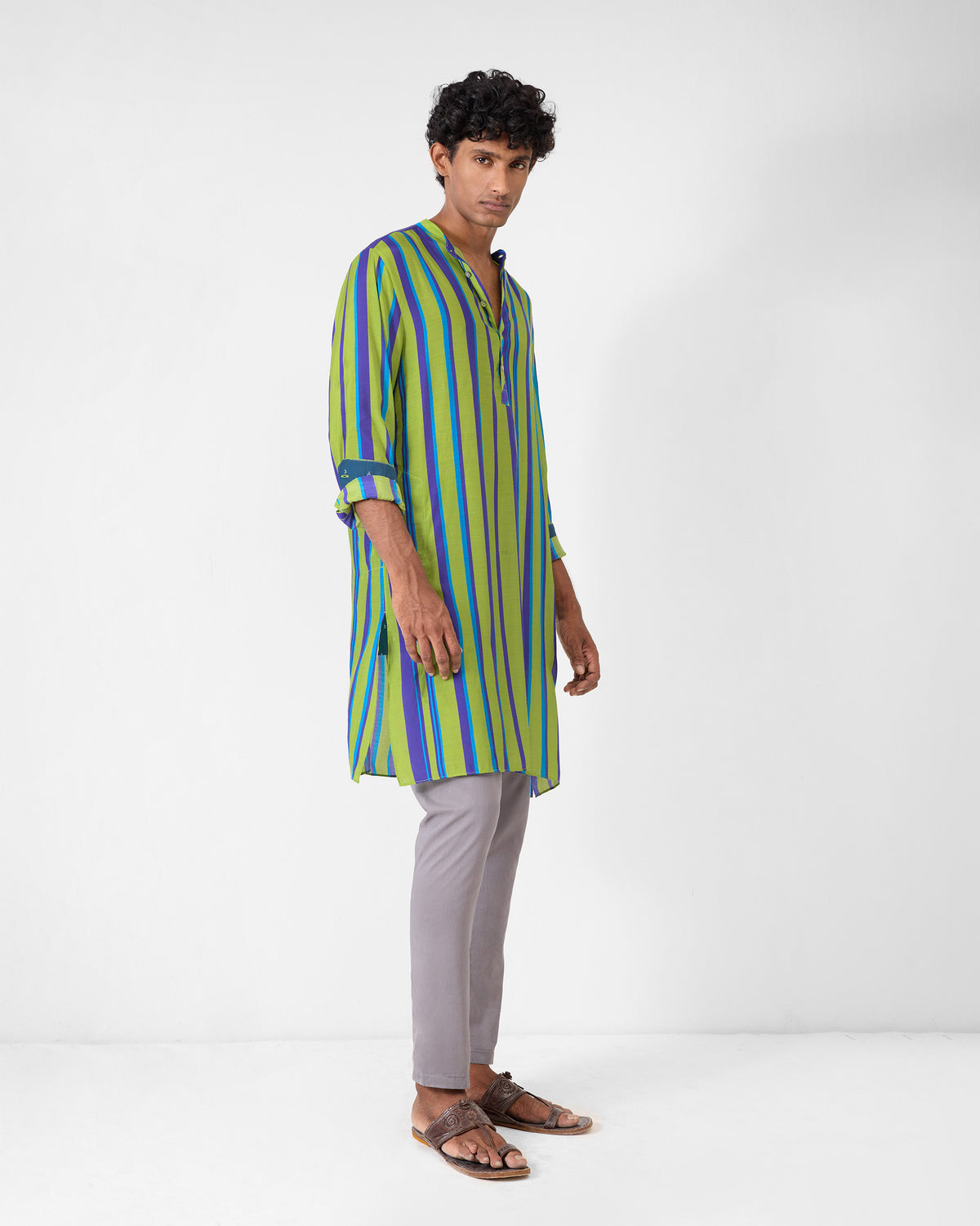 Person wearing a green and blue striped Jashn kurta with a neckband collar.