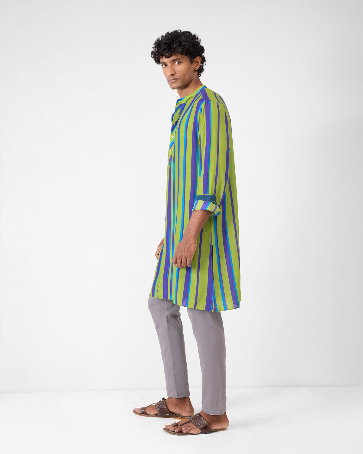 Side view of a green and blue striped Jashn kurta with a side slit.