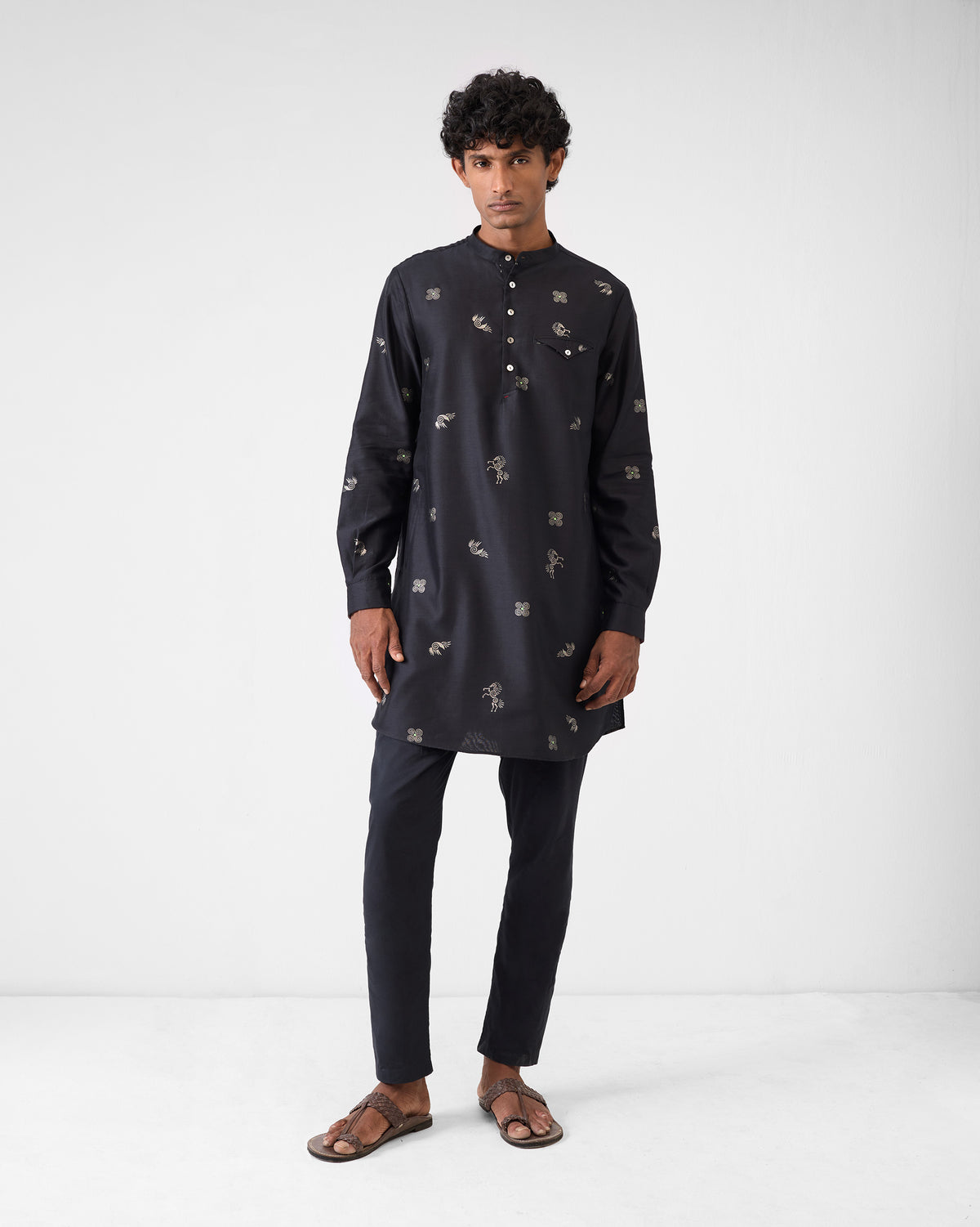 Person wearing a black Fort Kurta with an all-over silver foil print.